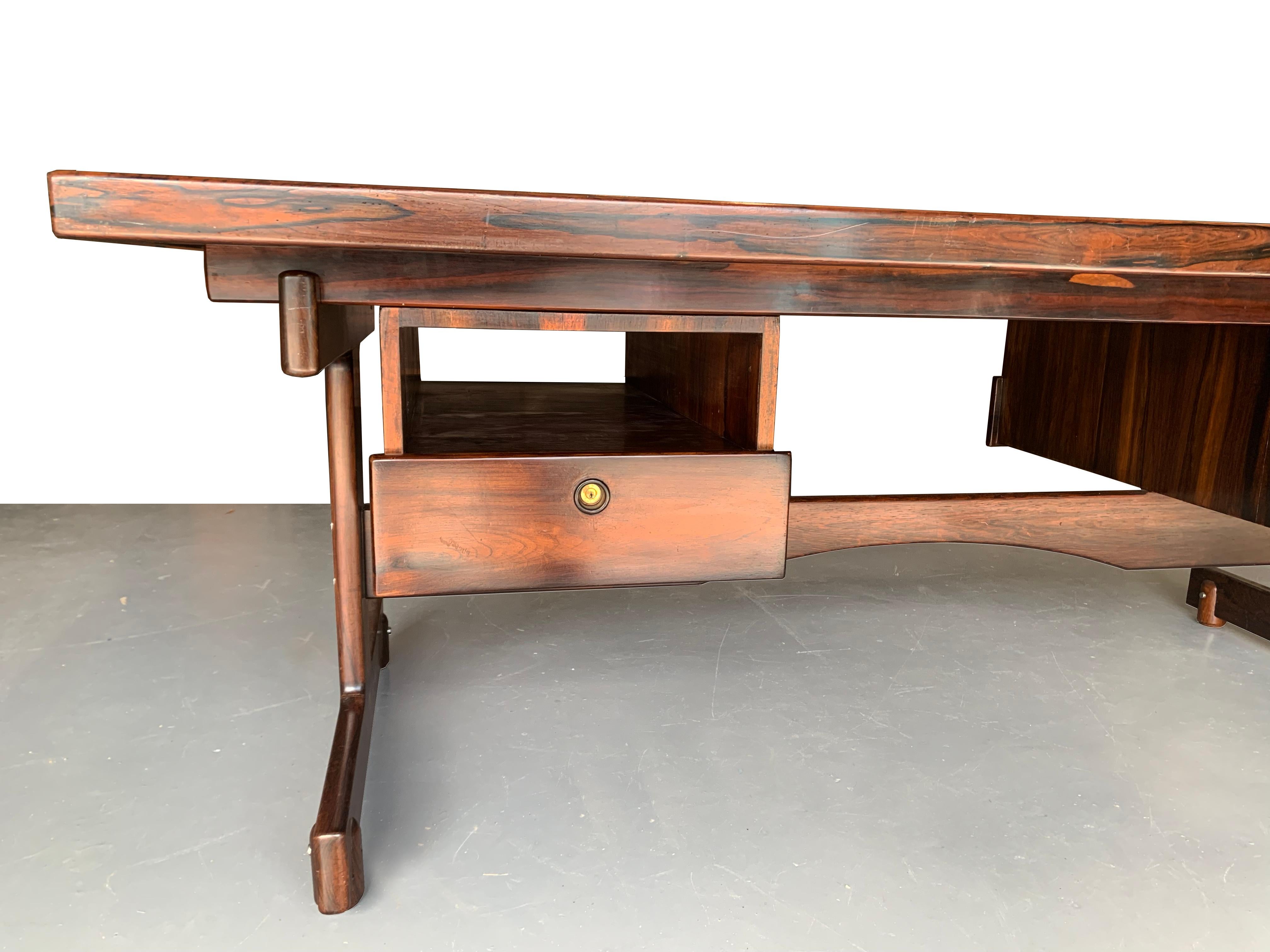 Gordon Desk
A classic item by designer Sérgio Rodrigues. 
1962, Brazil
Structure in solid wood; top in veneered wood, framed by solid wood. 
Two boxes with one drawer and one opening each, onto a double 