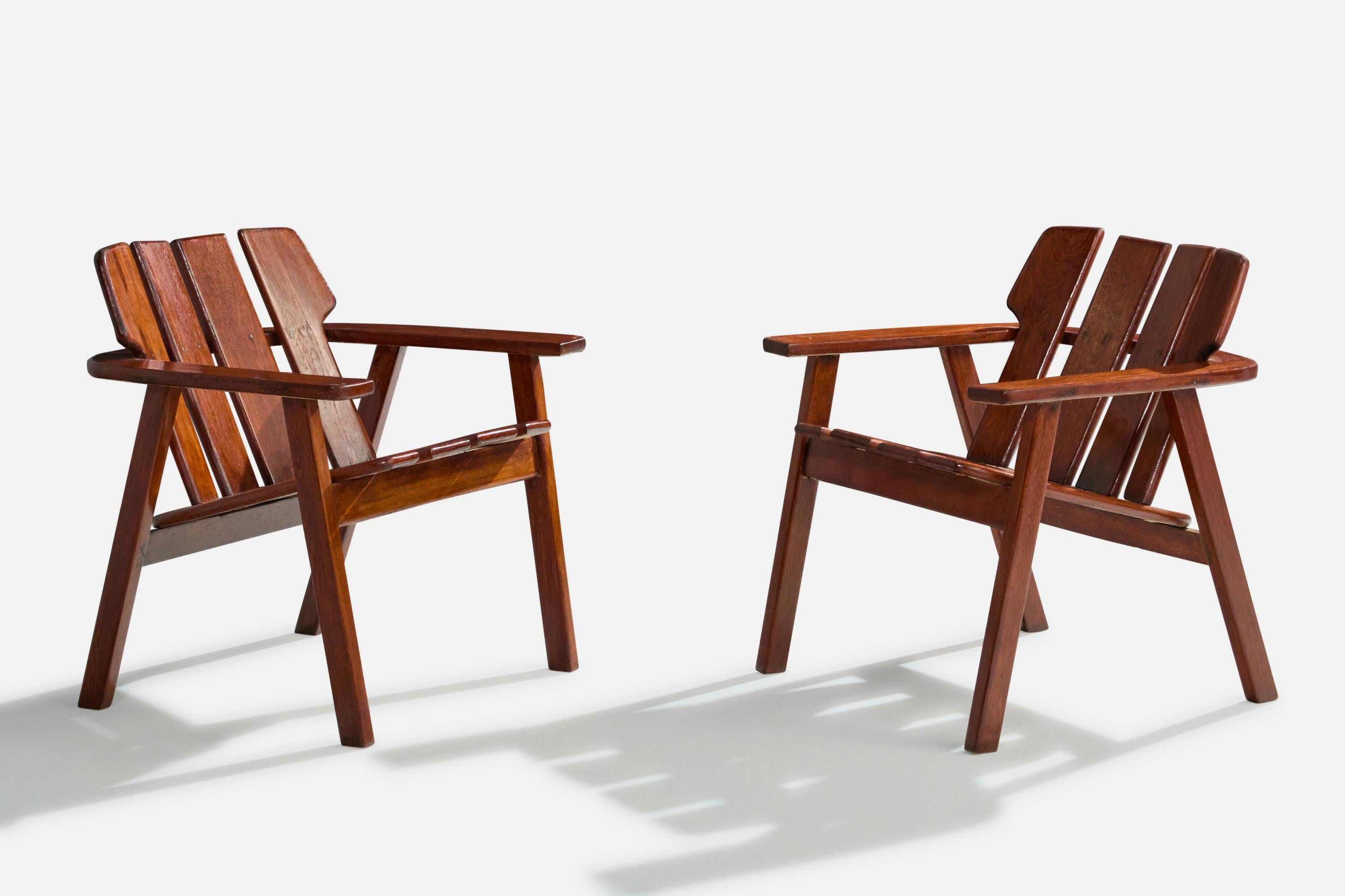 A pair of wood lounge chairs or armchairs designed and produced by Sergio Rodrigues, Brazil, c. 1978.

Very light scratching on backrest of one chair and arm of the other. Refinished at some point in history.

Overall Dimensions (inches): 26.75” H x