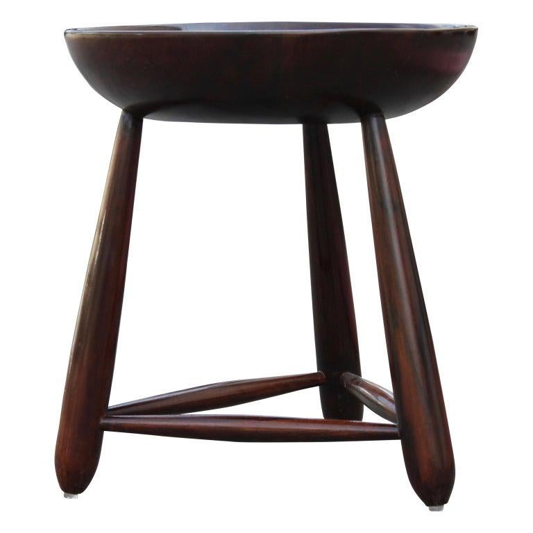 Mid-Century Modern 'Mocho' stool in jacaranda´ wood by Brazilian designer Sergio Rodrigues. Each with concave seat and handle, on turned bulbous form legs with spreader bars. Good vintage condition, consistent with age and use.
 