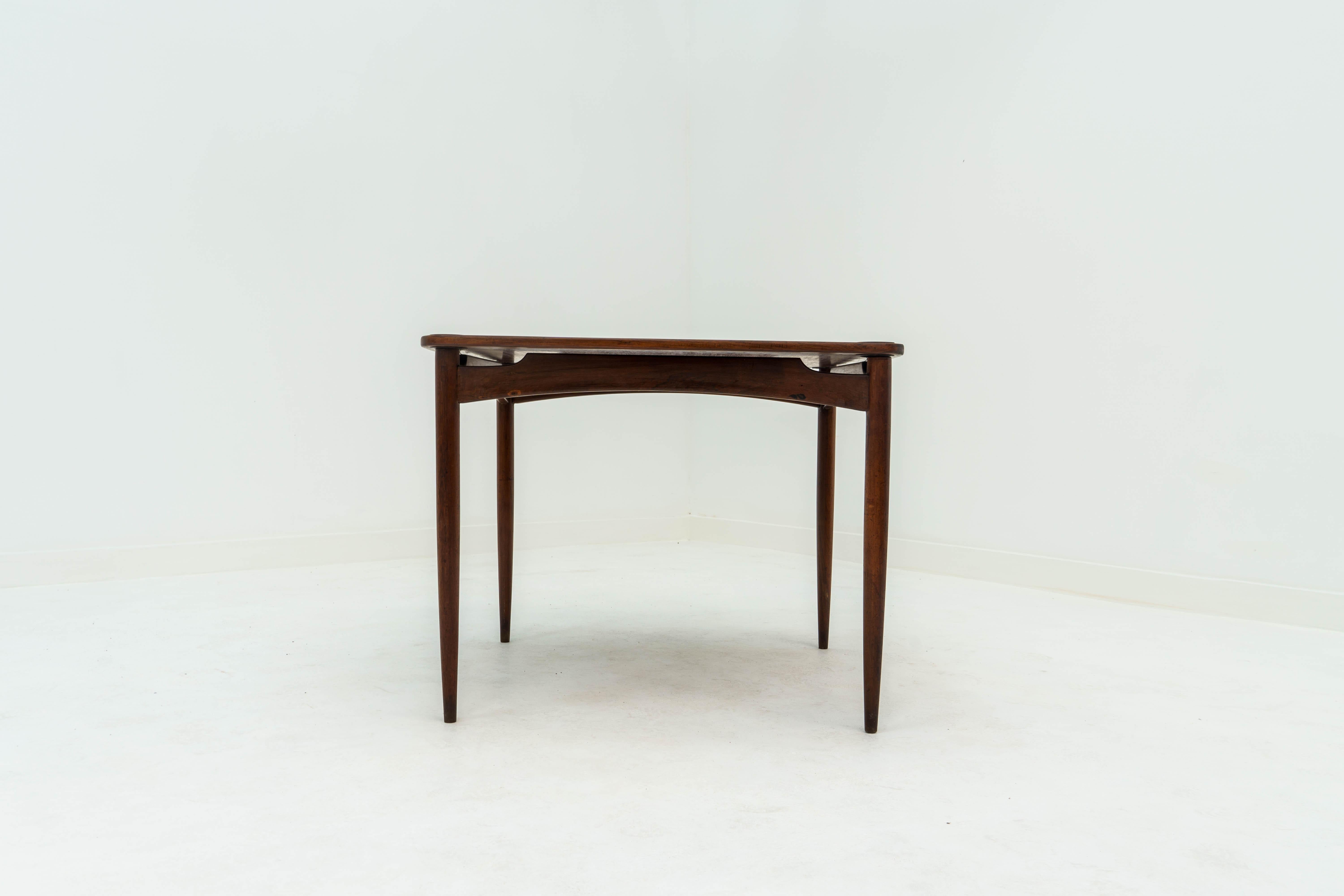 The Norma table by Sergio Rodrigues is a versatile and iconic piece of mid-century modern furniture. Designed in 1964, it features top finished in rosewood. The table's clean lines and elegant form exemplify Rodrigues' signature style, which often