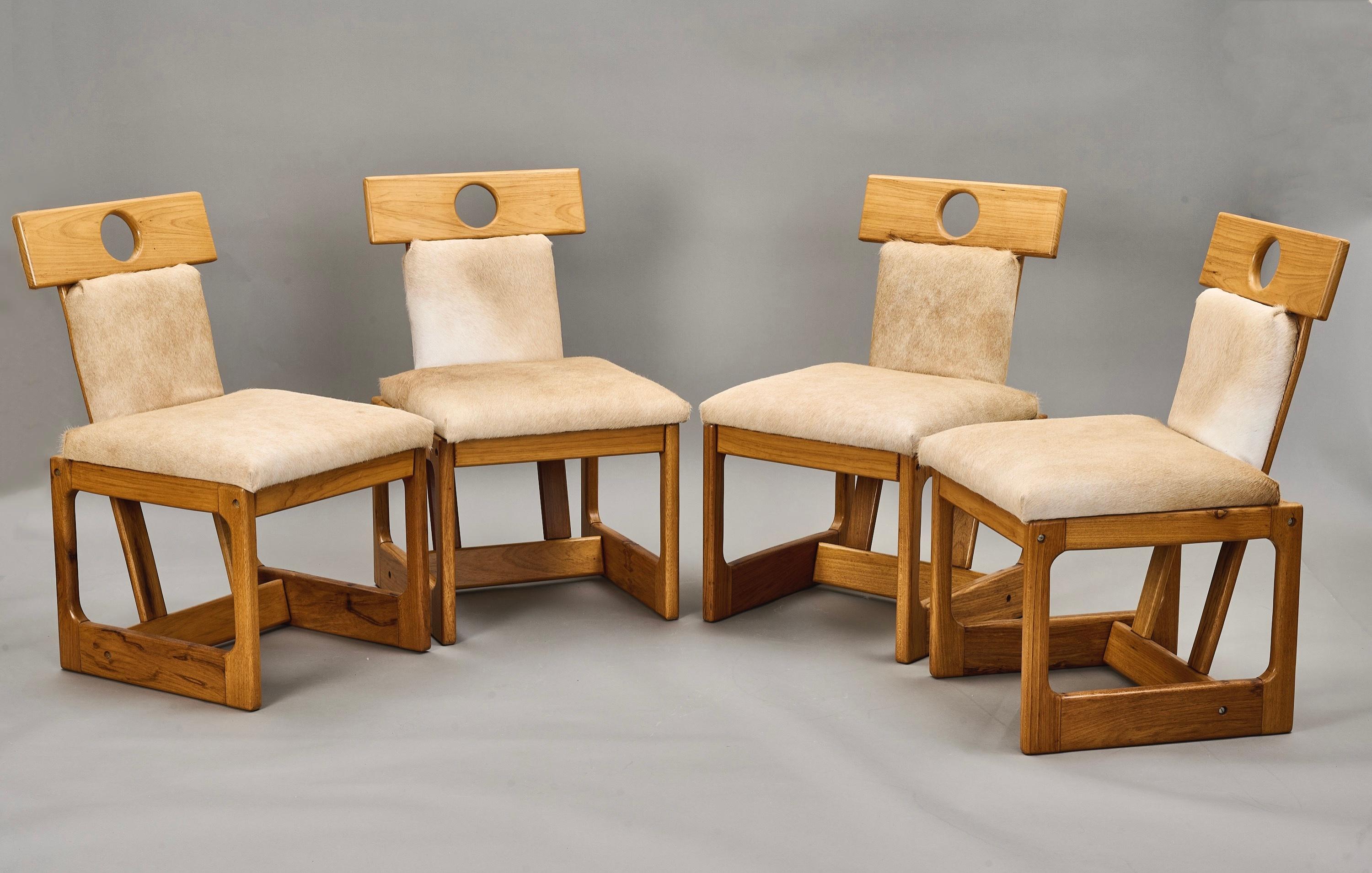 Sergio Rodrigues (1927–2014)

A set of four Cuiaba dining chairs by Brazilian design pioneer Sergio Rodrigues, in caviona wood upholstered in cream-colored cowhide. The chairs' geometric form rests on a pair of rectangular legs, the construction and