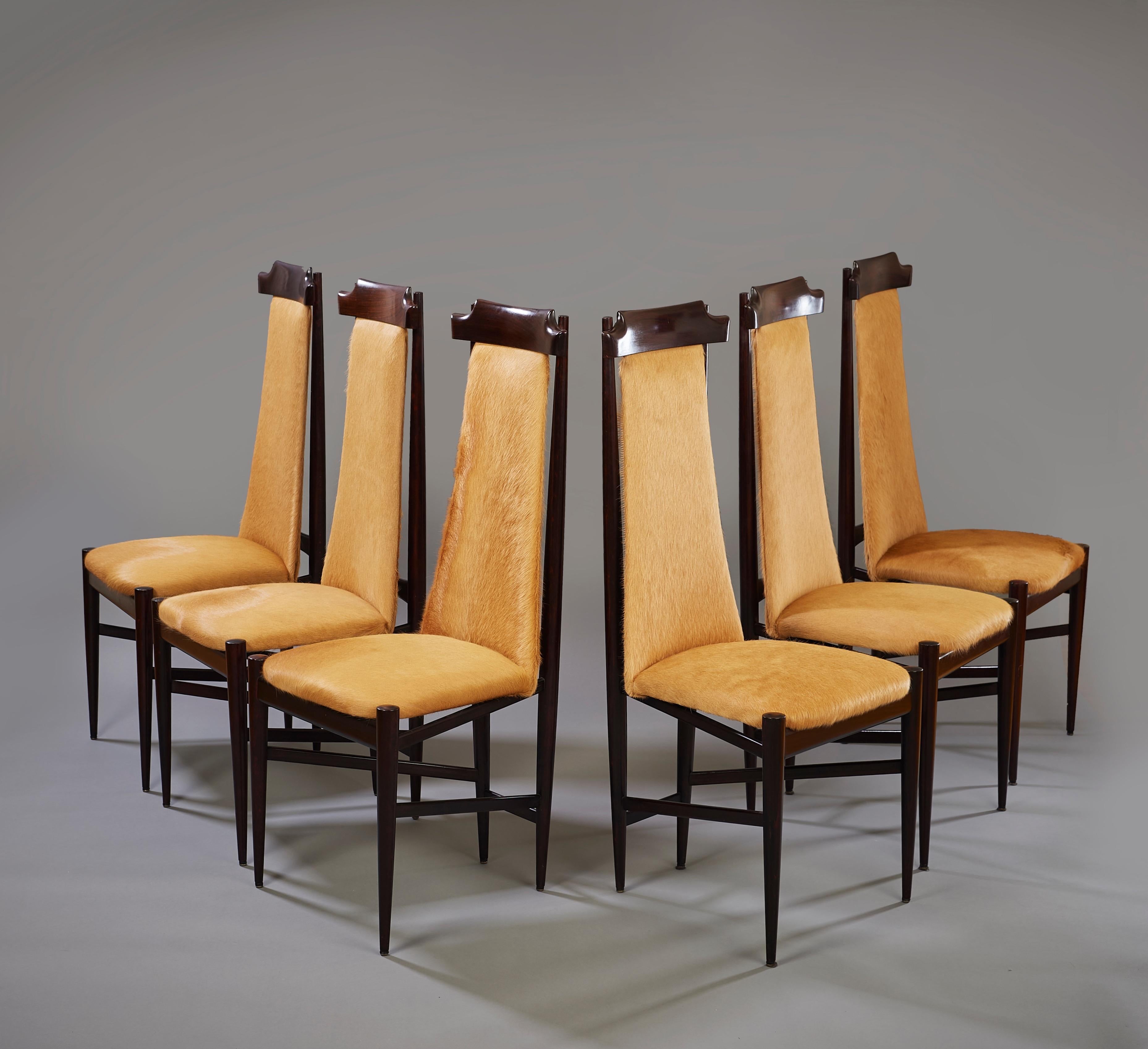 Sergio Rodrigues (1927–2014)

A striking set of six modernist dining chairs by Carioca design pioneer Sérgio Rodrigues, in hardwood upholstered in unshaved caramel-colored cowhide. The chairs synthesize a unique combination of Shaker, De Stijl, and