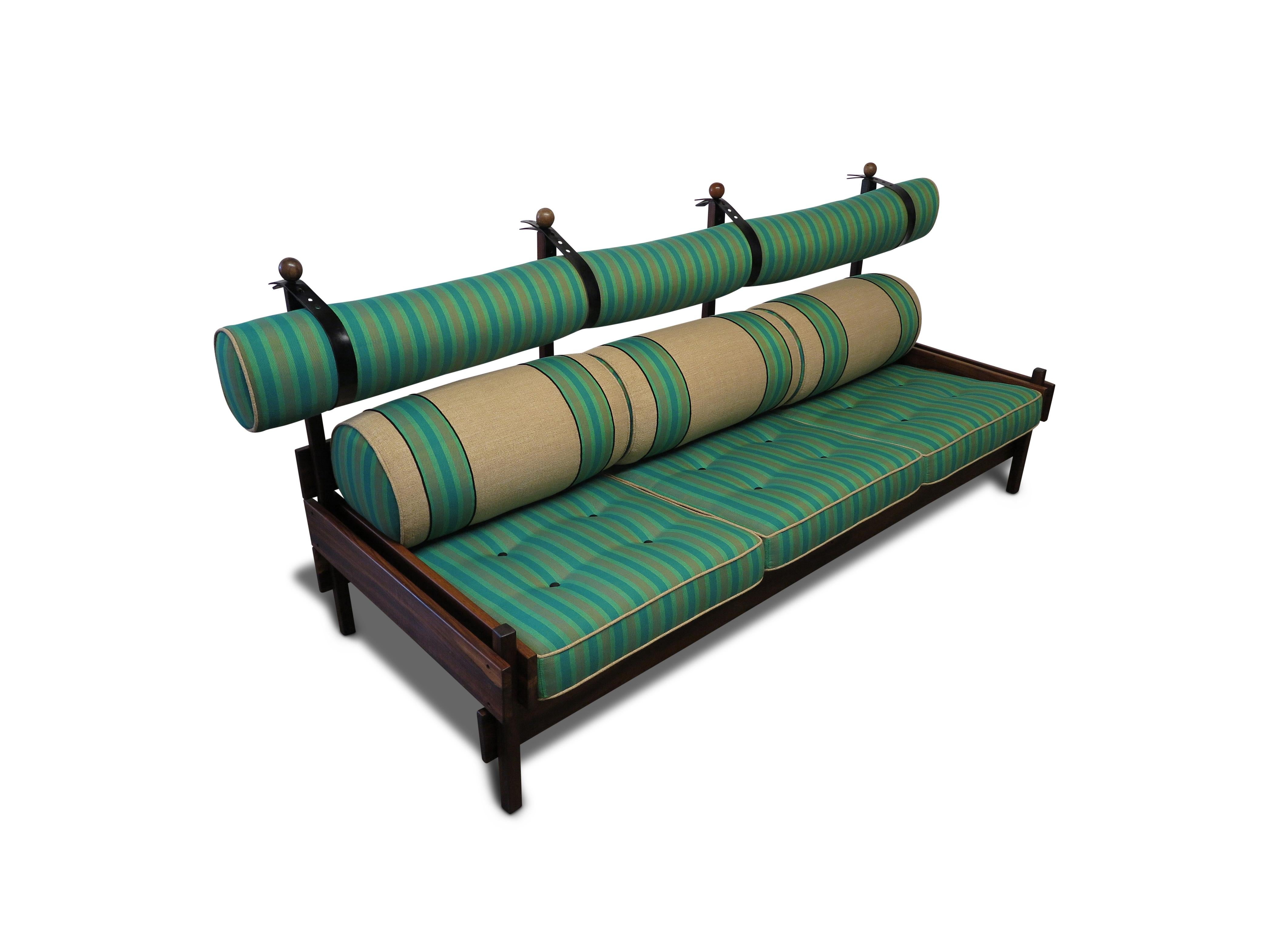 Iconic Sergio Rodrigues Tonico Sofa produced by OCA/Meia-Pataca in 1962, features a frame of solid Pau Ferro wood, in a reddish-brown color reimagined with handwoven Moroccan striped upholstery by David Kleinberg Design Associates for the 2025 San