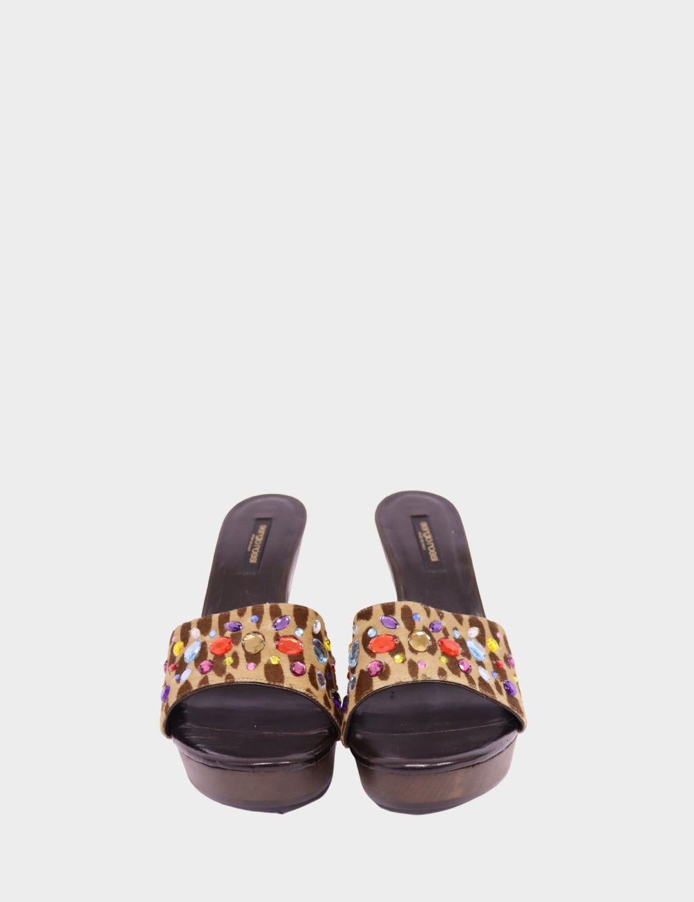 Atrévete con estas glamurosas sandalias de plataforma de Sergio Rossi. Con una llamativa tira de estampado de leopardo adornada con vibrantes adornos de gemas multicolores, estos tacones deslizantes destilan un lujo juguetón. Confeccionadas con una