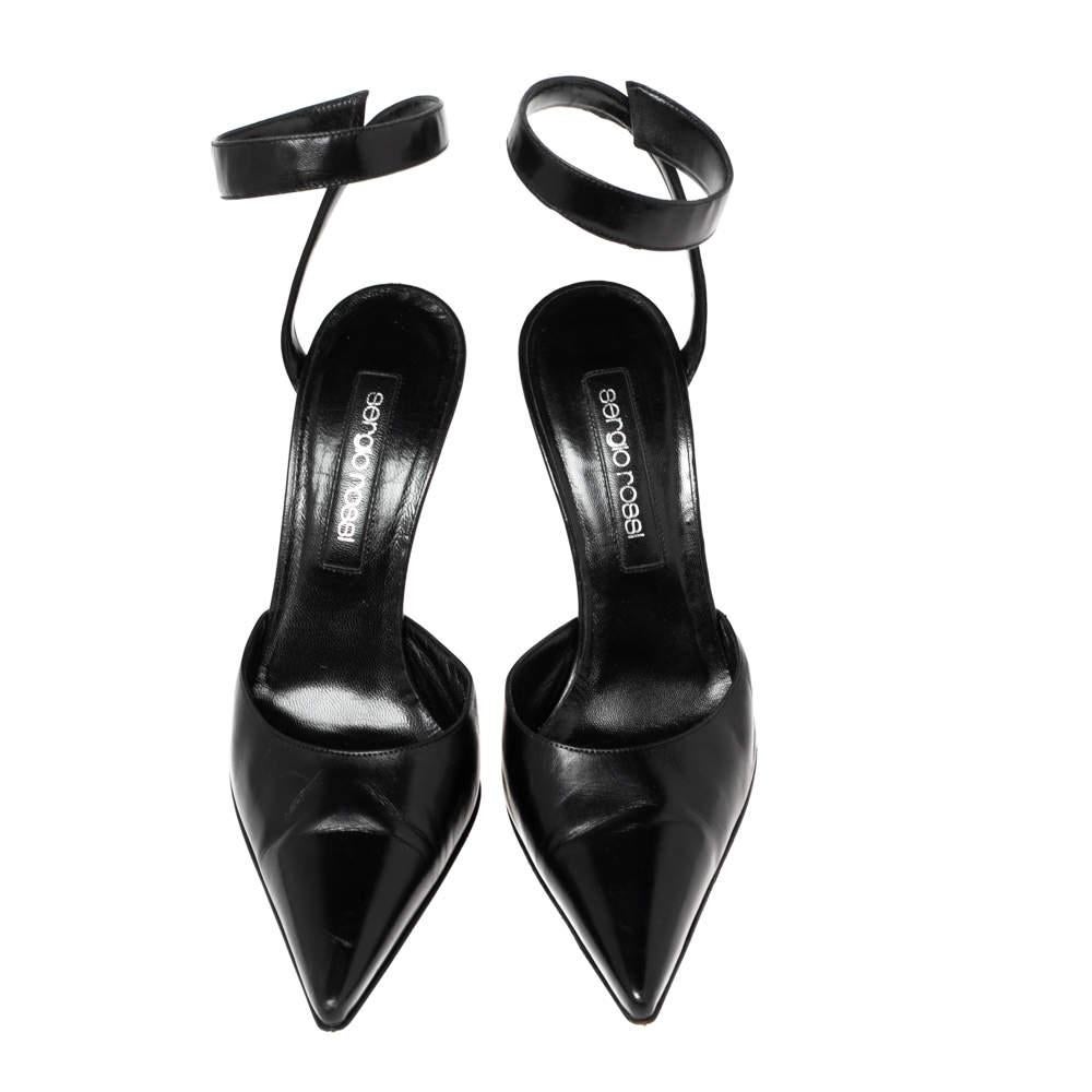 Meticulously created into a sleek silhouette, these pumps from the House of Sergio Rossi bring nothing but definition and edge to your ensemble. They are made from black leather and exhibit pointed toes, slim heels, and an ankle wrap feature. Treat