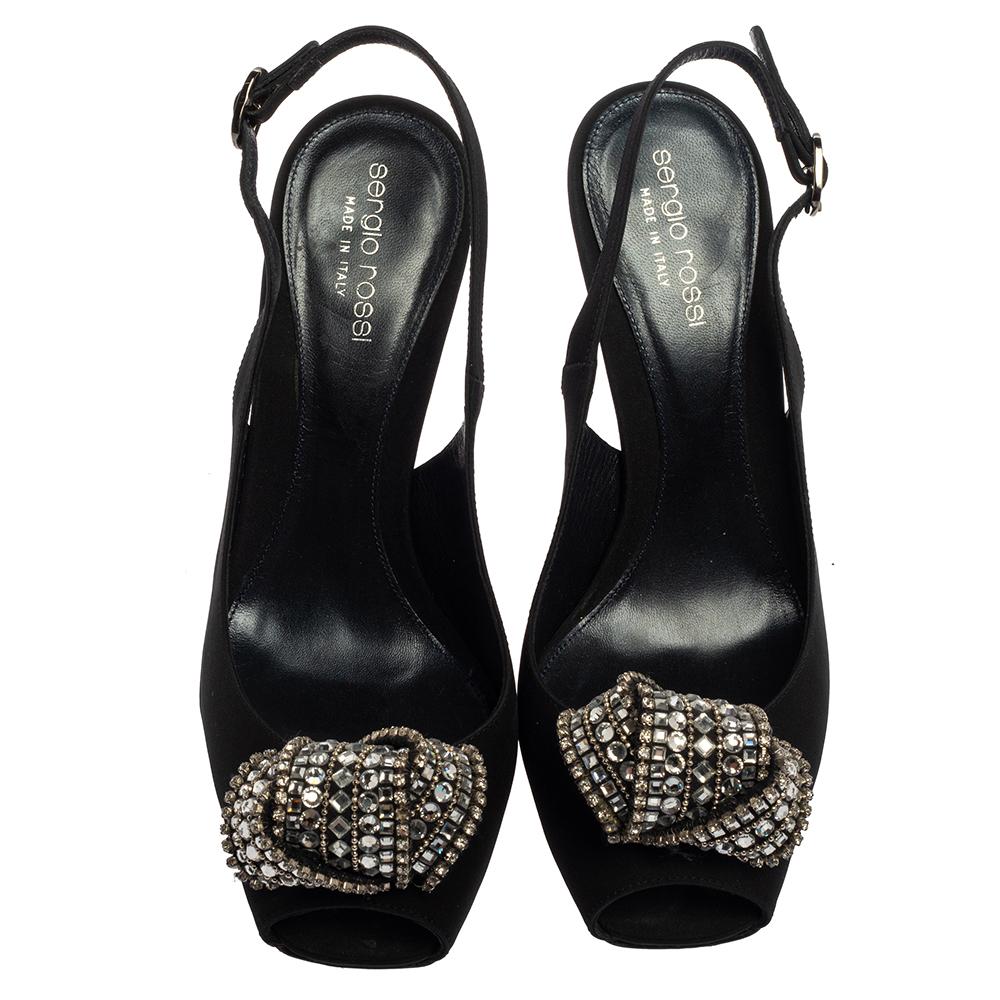 Create the most eye-catching party looks wearing these super stylish Sergio Rossi sandals. Constructed from black satin, these square peep-toe sandals along with their slingbacks and 10.5 cm heels, feature exquisite crystal-embellished knot motifs