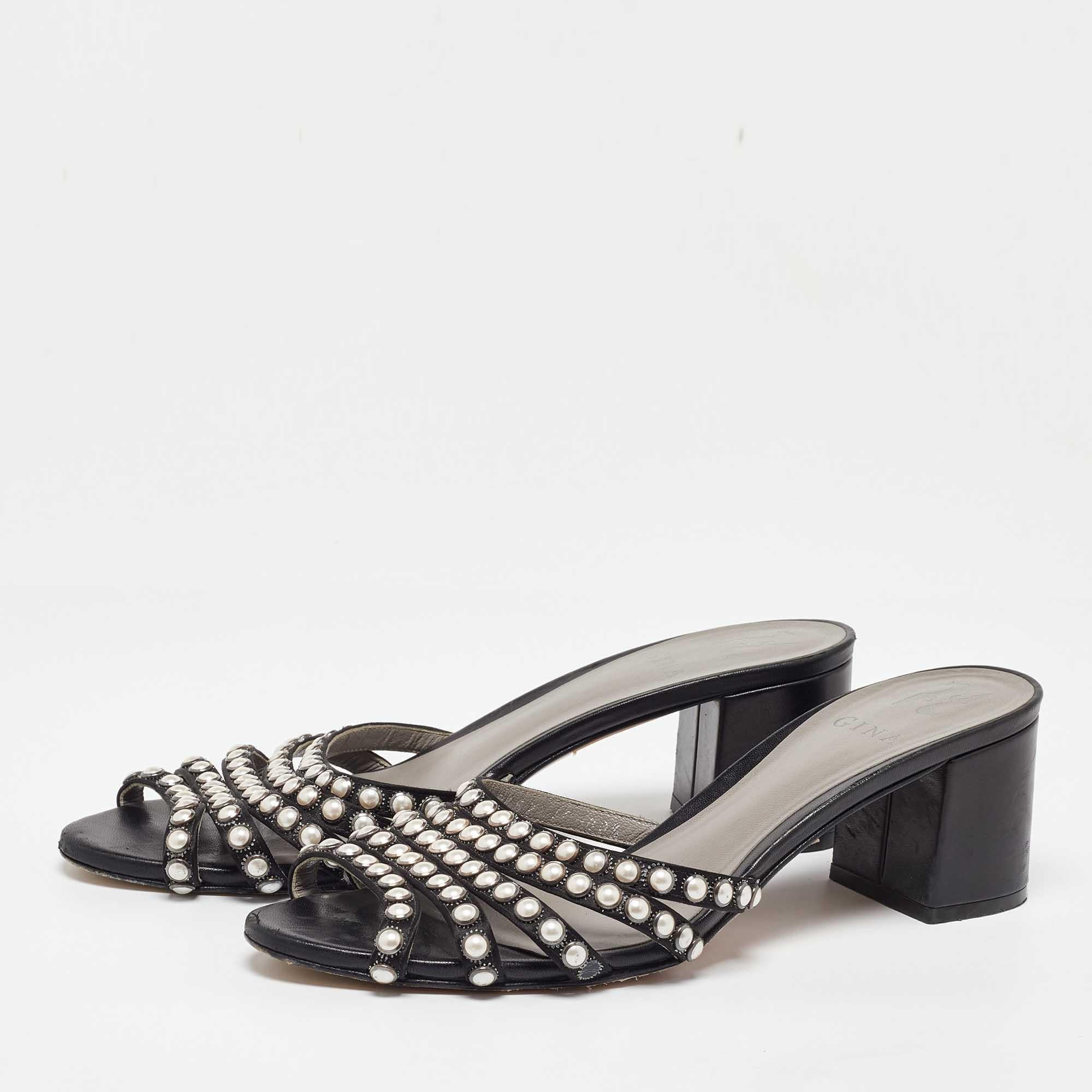 The House of Sergio Rossi brings us these timeless sandals that make us marvel at their beauty and craftsmanship. Crafted from black satin on the exterior  these slide sandals are adorned with pearl embellishments on the straps. Look stunning as you