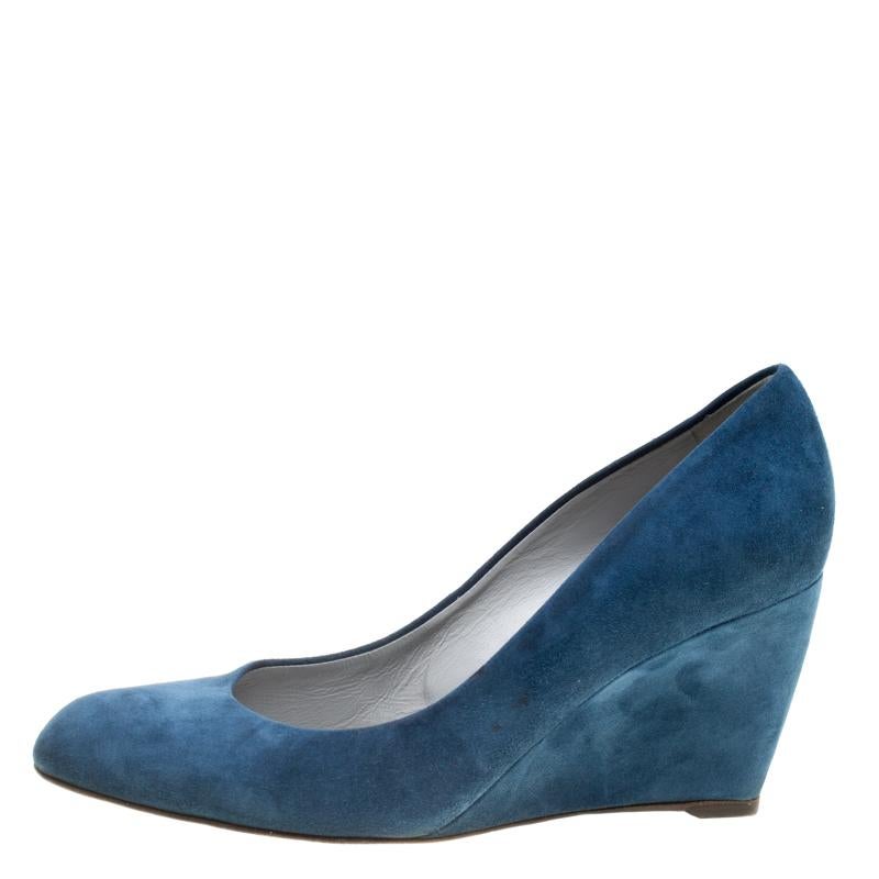 Embrace comfort and style all the way by owning these stunning Sergio Rossi pumps today! Crafted from blue suede, they have been styled with round toes and wedge heels. The insoles have been lined with leather and they will offer you