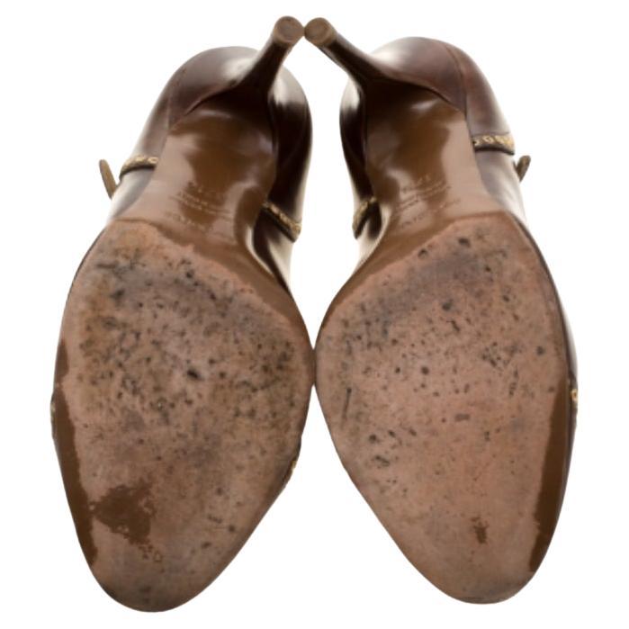 Cammina con stile con questo paio di décolleté della casa di Sergio Rossi. Progettato in una tonalità marrone, questo paio di scarpe presenta un occhiello impreziosito sulla superficie, un cinturino con fibbia e un tacco a spillo da quattro pollici.