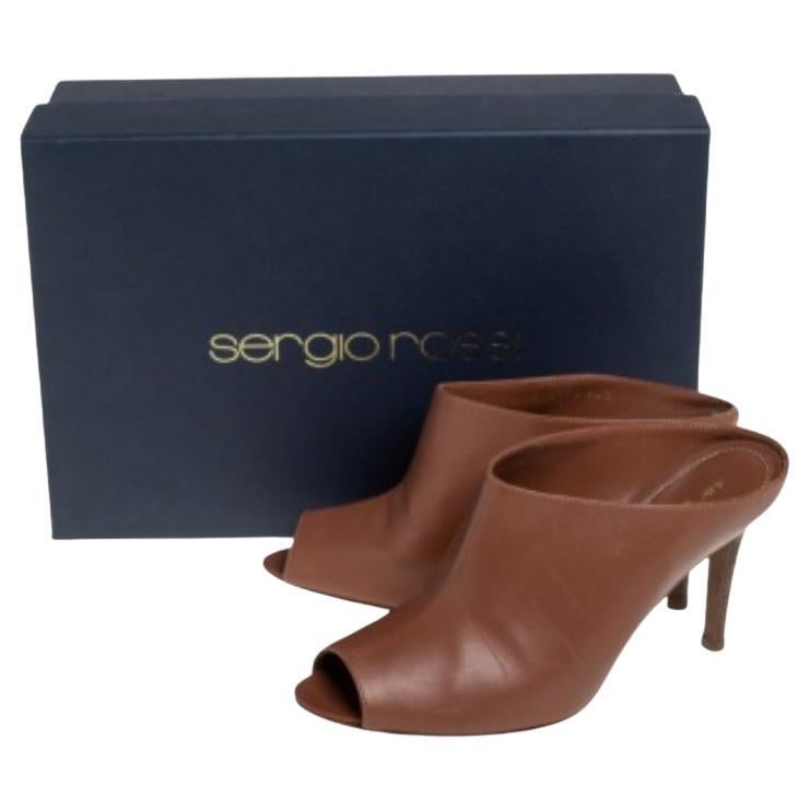 We're greatly impressed by these mule sandals from Sergio Rossi! They are crafted from brown leather and styled with a peep toe and an open-back silhouette. Comfortable leather-lined insoles and 9 cm stiletto heels complete this fabulous pair.