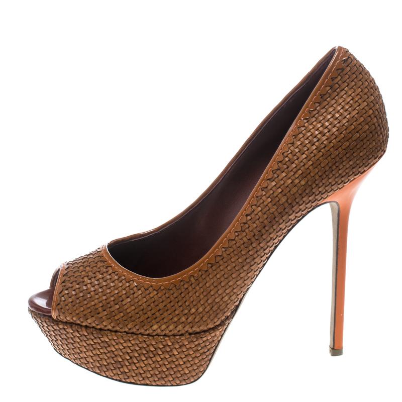 Designed by Sergio Rossi, this pair of pumps is a splendid mix of comfort and style. Look unique and trendy in this pair of winning pumps, crafted from woven leather. They feature peep toes, platforms and 14.5 cm heels.

Includes: The Luxury Closet