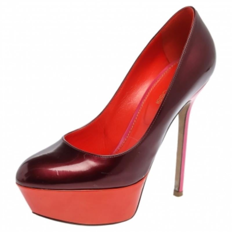 Burgundy and orange! Now that's a unique combination. These Sergio Rossi pumps, crafted from patent leather, feature almond toes, and well-cut vamps. They have been endowed with comfortable leather-lined insoles and elevated on solid platforms and
