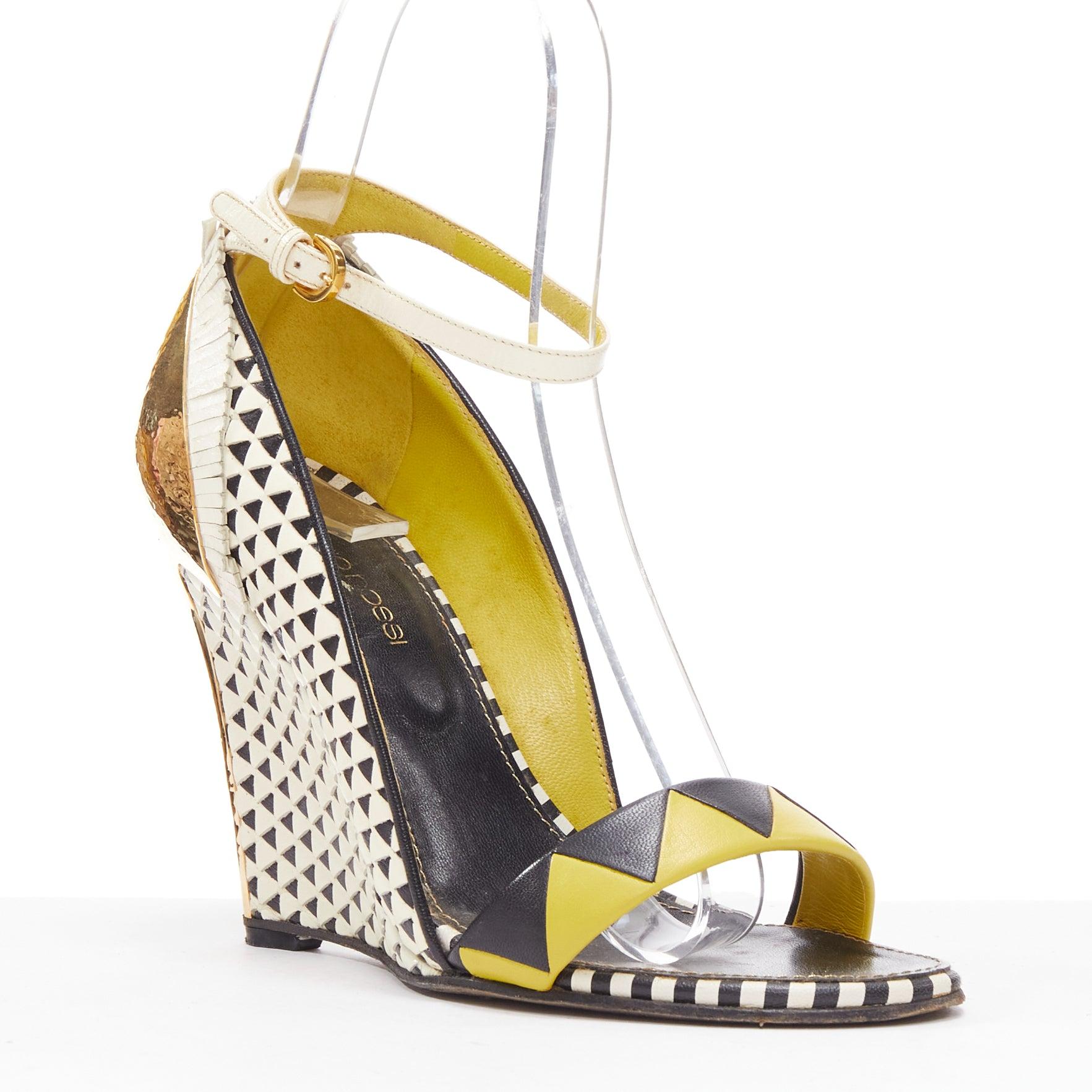 SERGIO ROSSI gold cap heel geometric yellow black wedge sandals EU36
Reference: EALU/A00037
Brand: Sergio Rossi
Material: Leather, Metal
Color: Black, Yellow
Pattern: Solid
Closure: Ankle Strap
Lining: Black Leather
Extra Details: Gold cap wedges