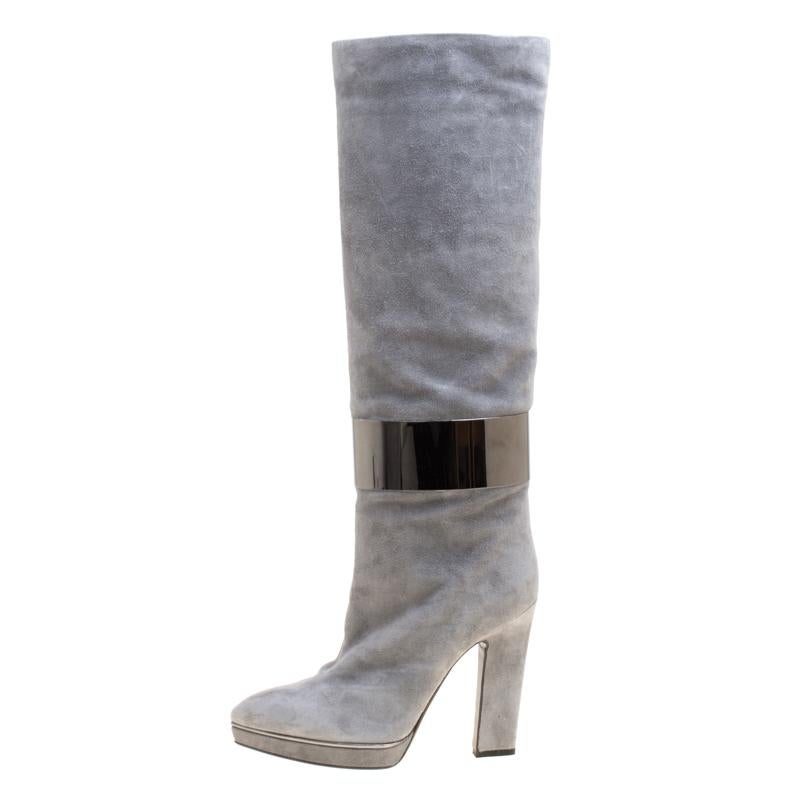 Creations as fashionable as this pair of knee high boots from Sergio Rossi deserves to be in every woman's closet. They've been created from suede and designed with metal cuffs, platforms and block heels.

Includes: Original Box

