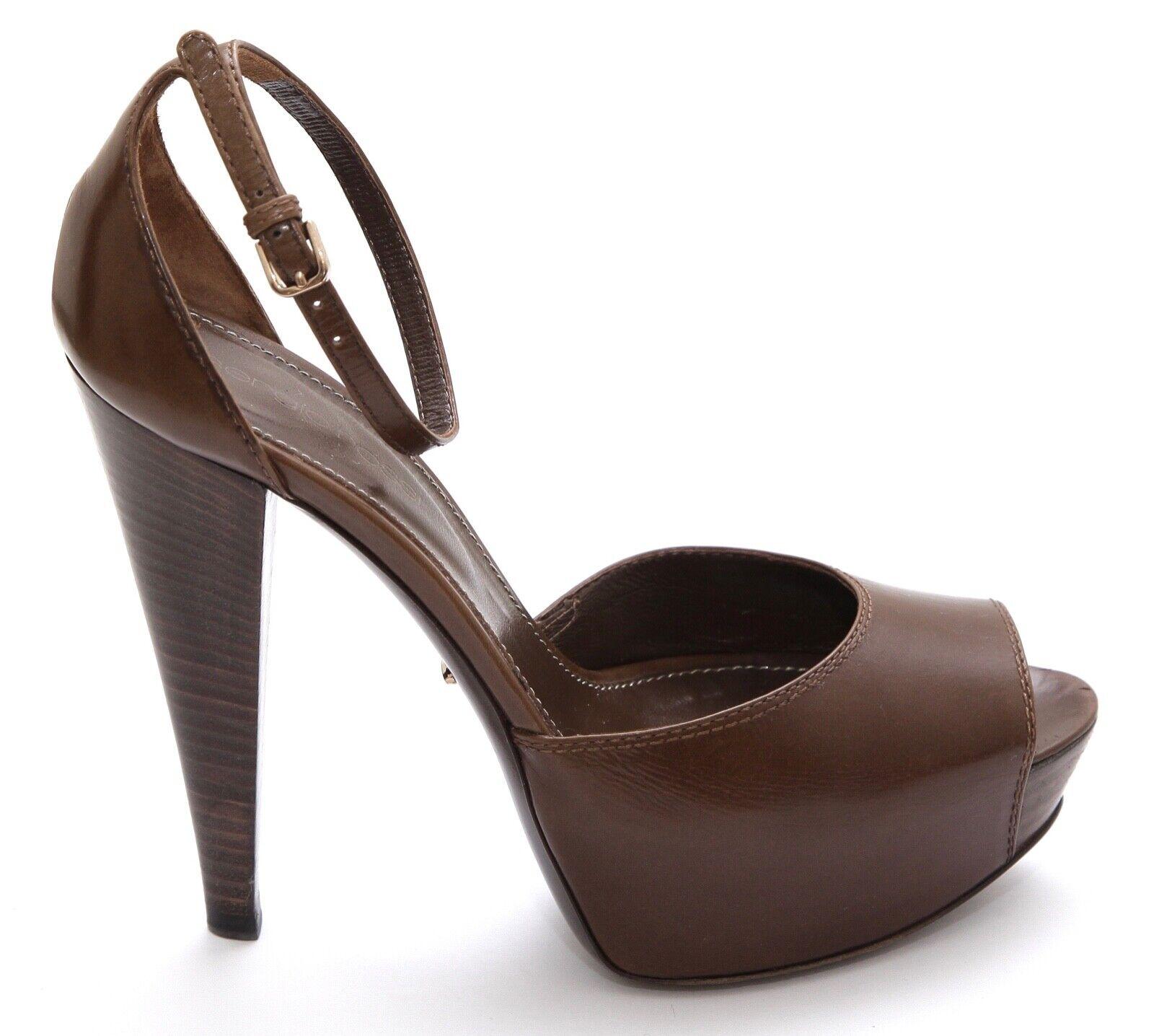 GUARANTEED AUTHENTIC SERGIO ROSSI BROWN LEATHER PEEP TOE PLATFORM PUMP

Design:
- Brown leather covered platform pump/sandal.
- Peep toe.
- Covered platform.
- Leather ankle strap.
- Leather lining and sole.
- Comes with dust bag and box.

Size: