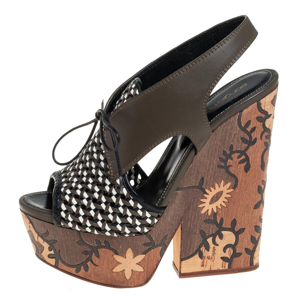 These Sergio Rossi sandals feature a leather upper beautifully complemented by patterns on the platforms and heels. The open-toe sandals are secured with lace-up ties.

Includes: Original Box, Info Booklet
