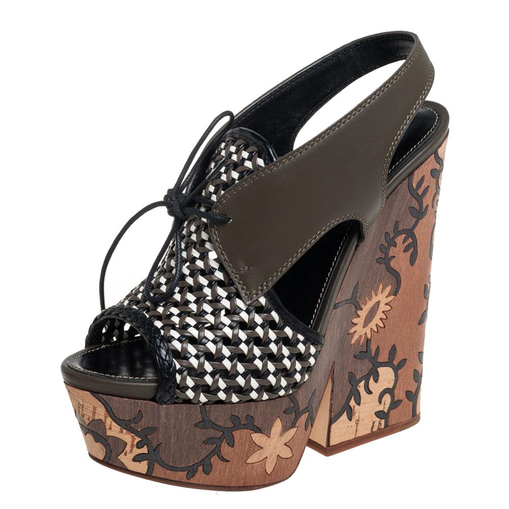 These Sergio Rossi sandals feature a leather upper beautifully complemented by patterns on the platforms and heels. The open-toe sandals are secured with lace-up ties.

