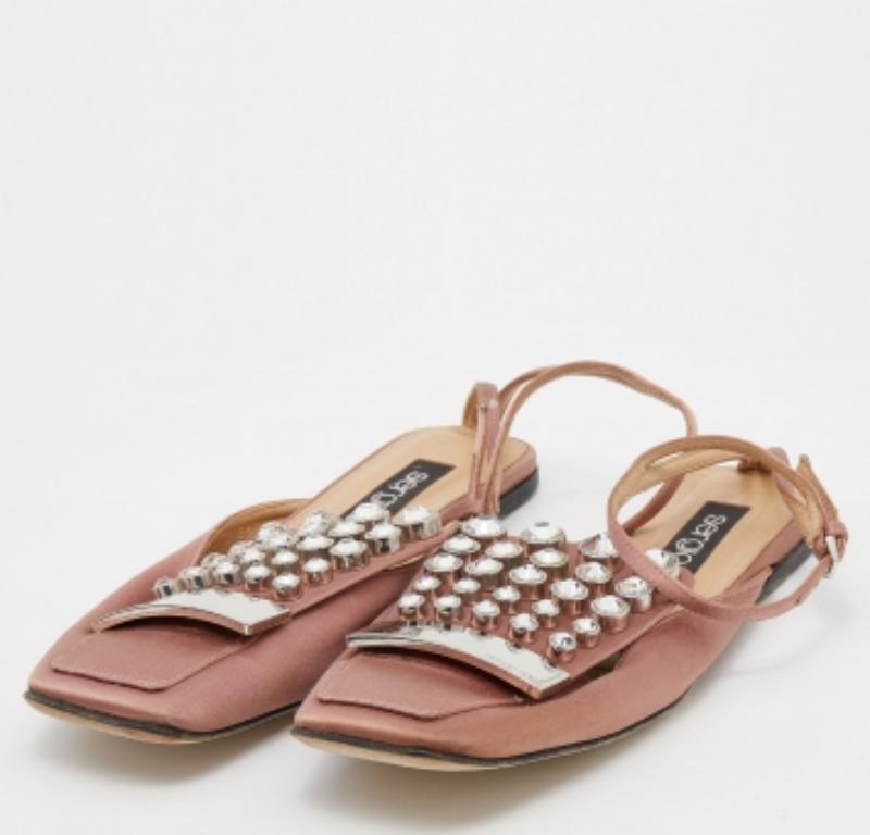 The satin exterior of these Sergio Rossi flats is set with attractive crystal embellishments and a branded metal plate. Defined by an ankle buckle closure, silver-tone hardware, and leather soles, this pair is an investment-worthy piece.
