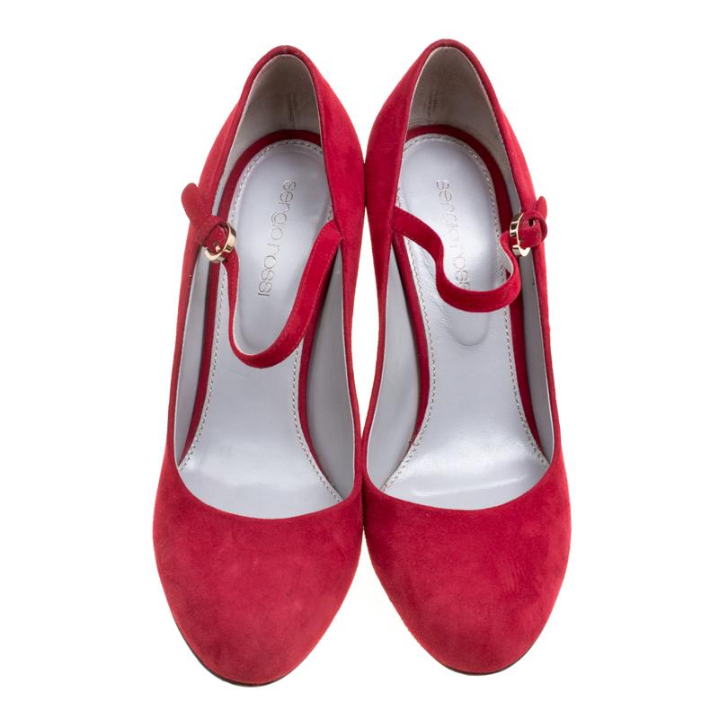 Go red all the way by owning these stunning Sergio Rossi pumps today! Crafted from suede, they have been styled with round toes, wedge heels and straps with buckles. The insoles have been lined with leather and they will offer you