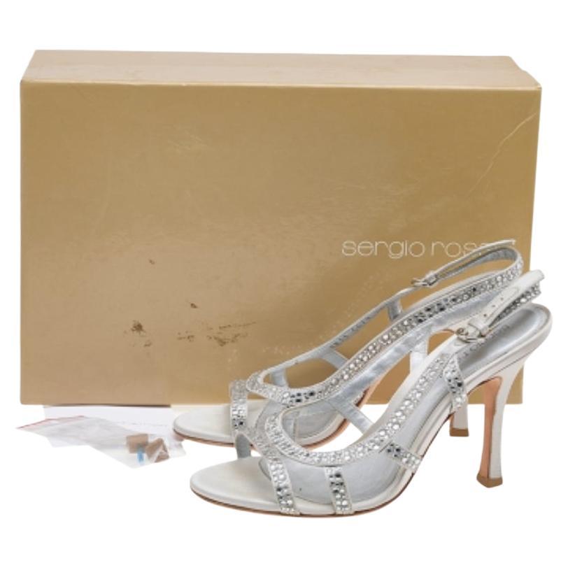 Pair your favorite outfit with these Sergio Rossi sandals for a stylish look. These beautiful sandals are a perfect option while choosing footwear for a special occasion. Crafted from satin, they come in a silver hue. They have a strappy silhouette