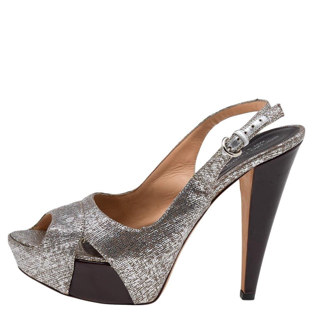 These magnificent sandals from Sergio Rossi are set on solid platforms and 13.5 cm heels. They have been crafted from textured leather and styled with peep toes cut out vamp straps and slingbacks. They are complete with comfortable leather lined
