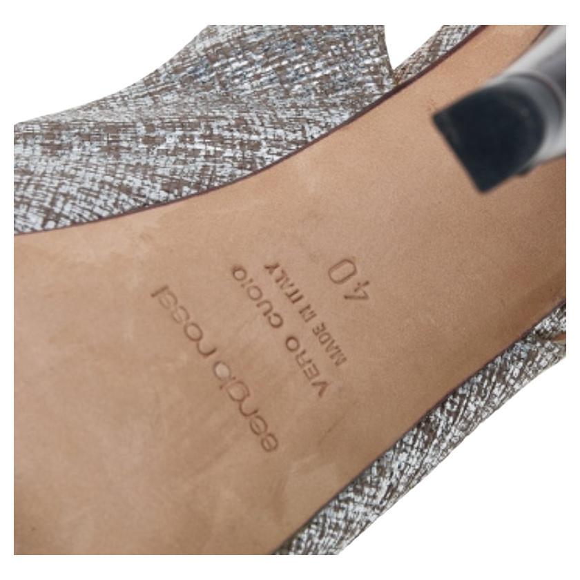 These magnificent sandals from Sergio Rossi are set on solid platforms and 13.5 cm heels. They have been crafted from textured leather and styled with peep-toes, cut-out vamp straps, and slingbacks. They are complete with comfortable leather-lined