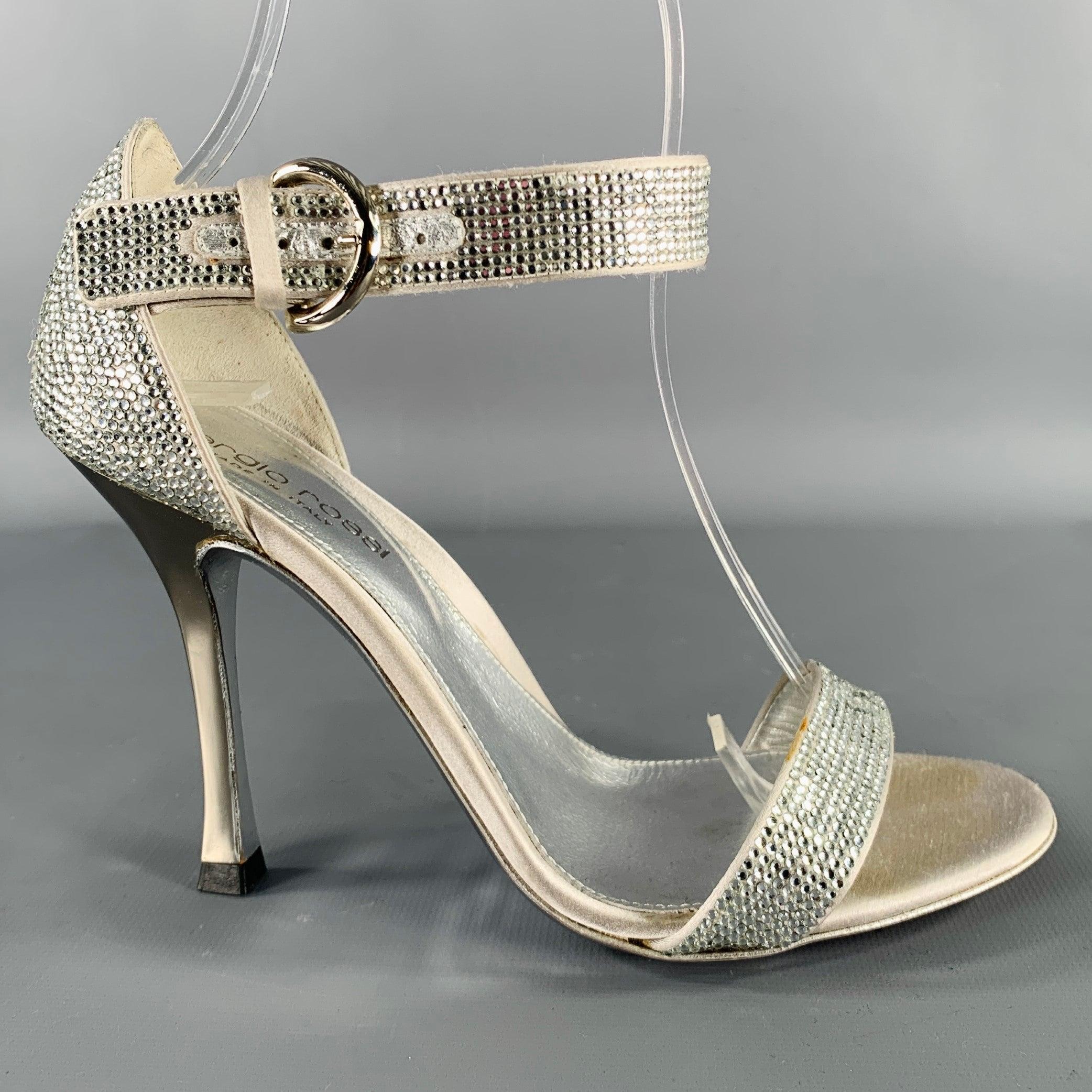 SERGIO ROSSI sandals
in a grey silk fabric featuring an all over silver tone rhinestone studded design, ankle strap, and buckle closure. Comes with dust bag. Made in Italy.Very Good Pre-Owned Condition. Missing rhinestone. 

Marked:   35.5