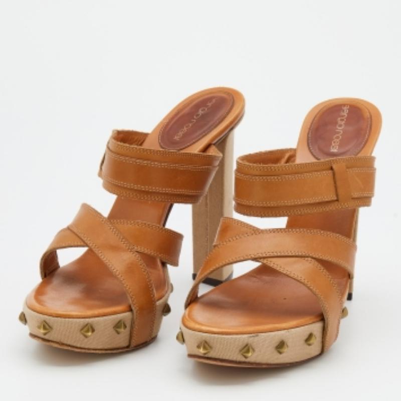 Simple, elegant, and comfortable, these Sergio Rossi sandals will make a fine addition to your shoe collection. They come designed with open toes, stud details, and strappy uppers. Elevated on platforms and 13 cm heels, this pair will make a worthy