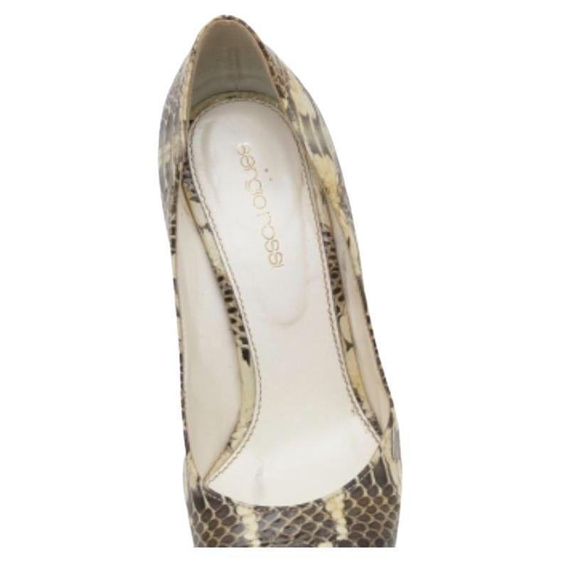 This pair of amazing pumps by Sergio Rossi sets the standard of sophistication. The water snake exterior gives the pair an amazing texture and the heels offer the appropriate elevation. Have a stylish day out with your friends while flaunting this
