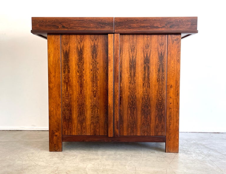Gorgeous Italian sideboard by Sergio and Giorgio Saporiti, circa 1960s
Unique shape and function - top tiers open up to reveal storage. 
2 Door cabinet with shelving. 
Jacaranda wood with incredible contrasting grain.
 