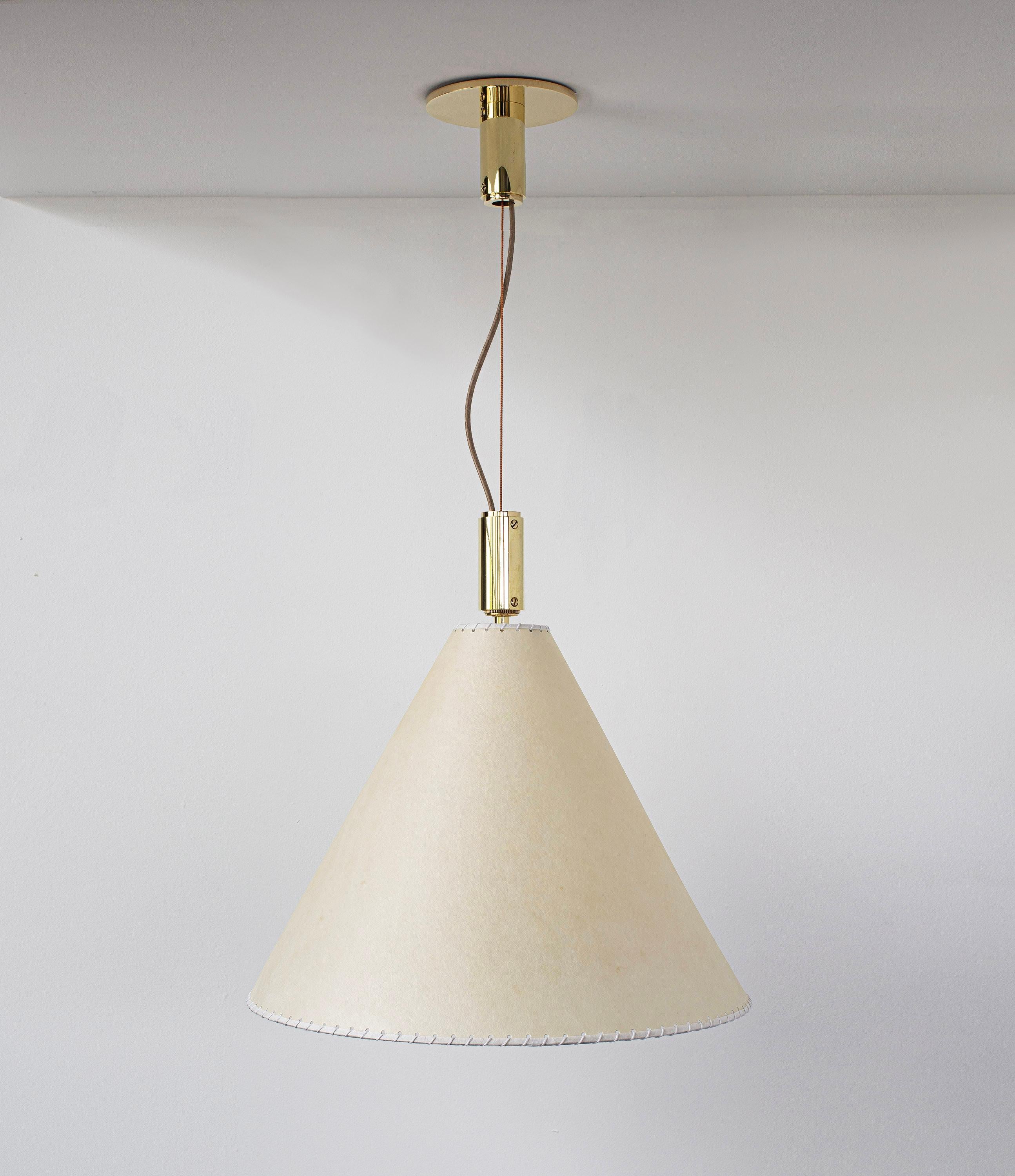 Solid machined brass, hand-stitched goatskin parchment shade with diffuser. Goatskin parchment is an excellent diffuser of light and is naturally figured and textured, similar to the surface of the moon.

All material finishes are living finishes: