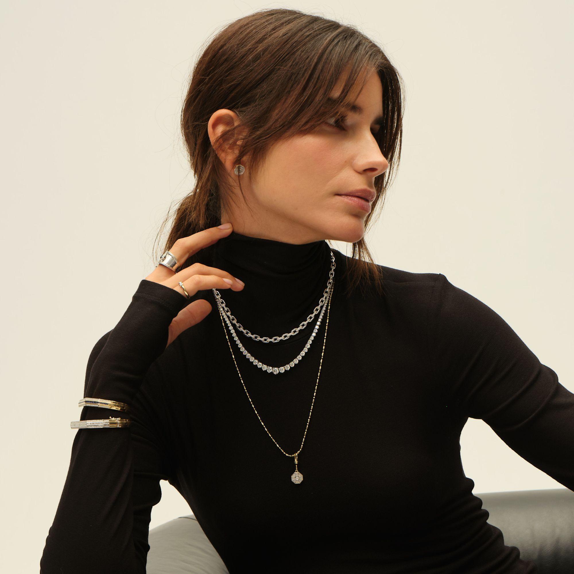 This refined necklace features an elegant chain-link design crafted in polished 14K white gold, blending strength with sophistication. Sparkling pavé-set diamonds are delicately integrated into select links, adding a subtle yet captivating