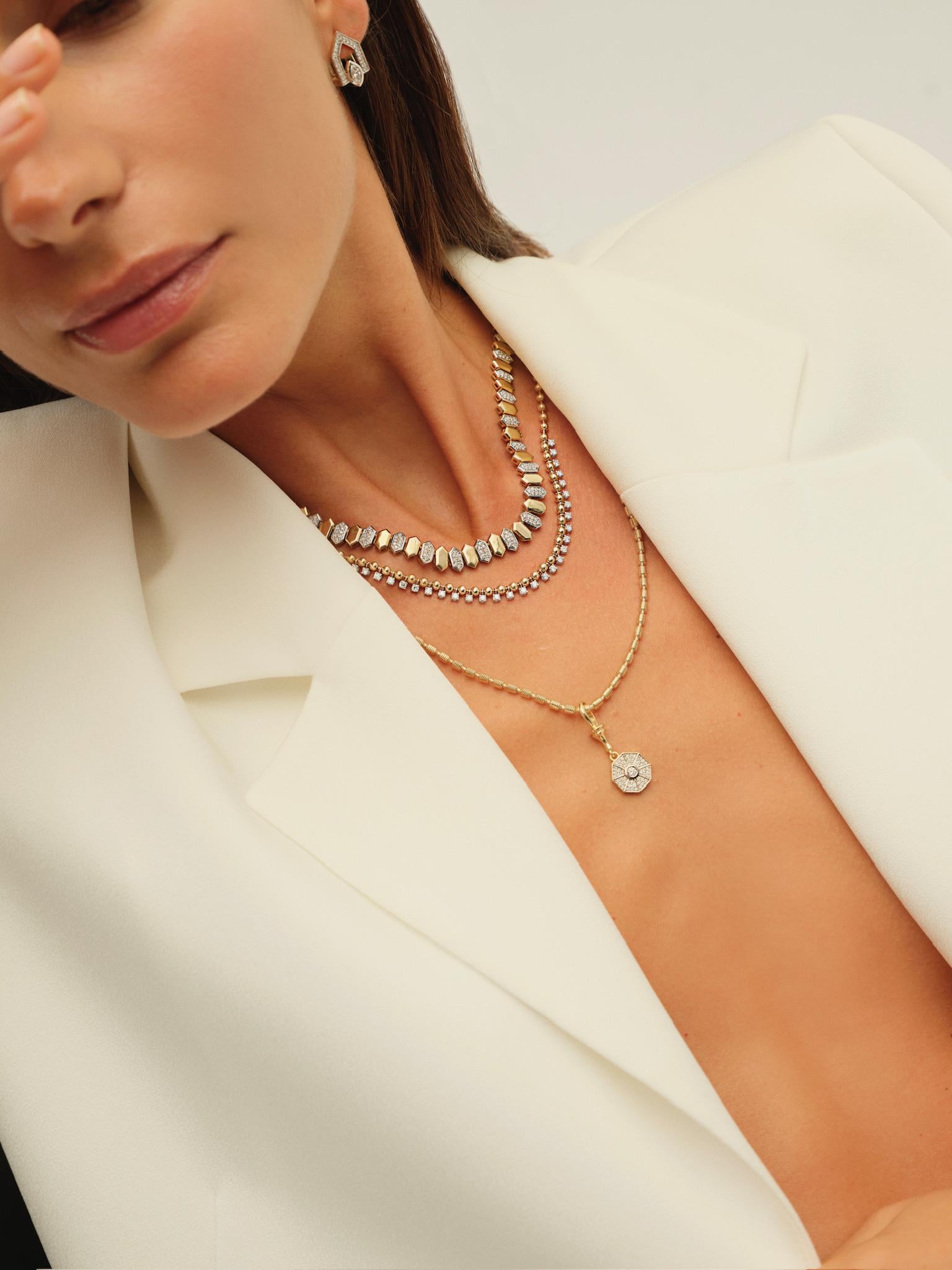 Make a bold statement with this contemporary necklace featuring sleek hexagonal links in rich yellow gold. Accented with alternating pavé-set diamond links in white gold, this geometric baklava design blends modern elegance with timeless brilliance.