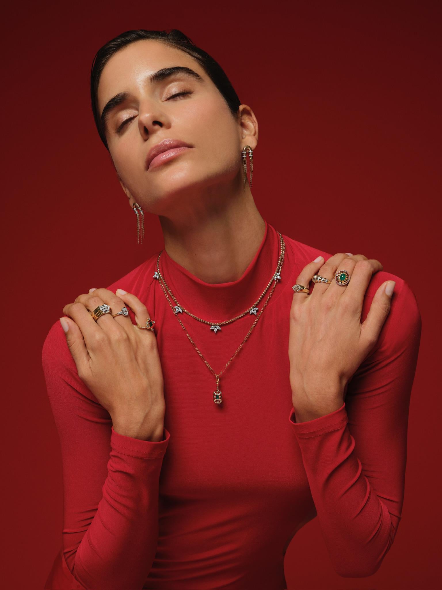 This delicate necklace features a string of small 14K yellow gold beads, elegantly spaced to form a refined silhouette. The design is accented by charming motifs of small clusters of shimmering diamonds — that are evenly distributed along the chain.