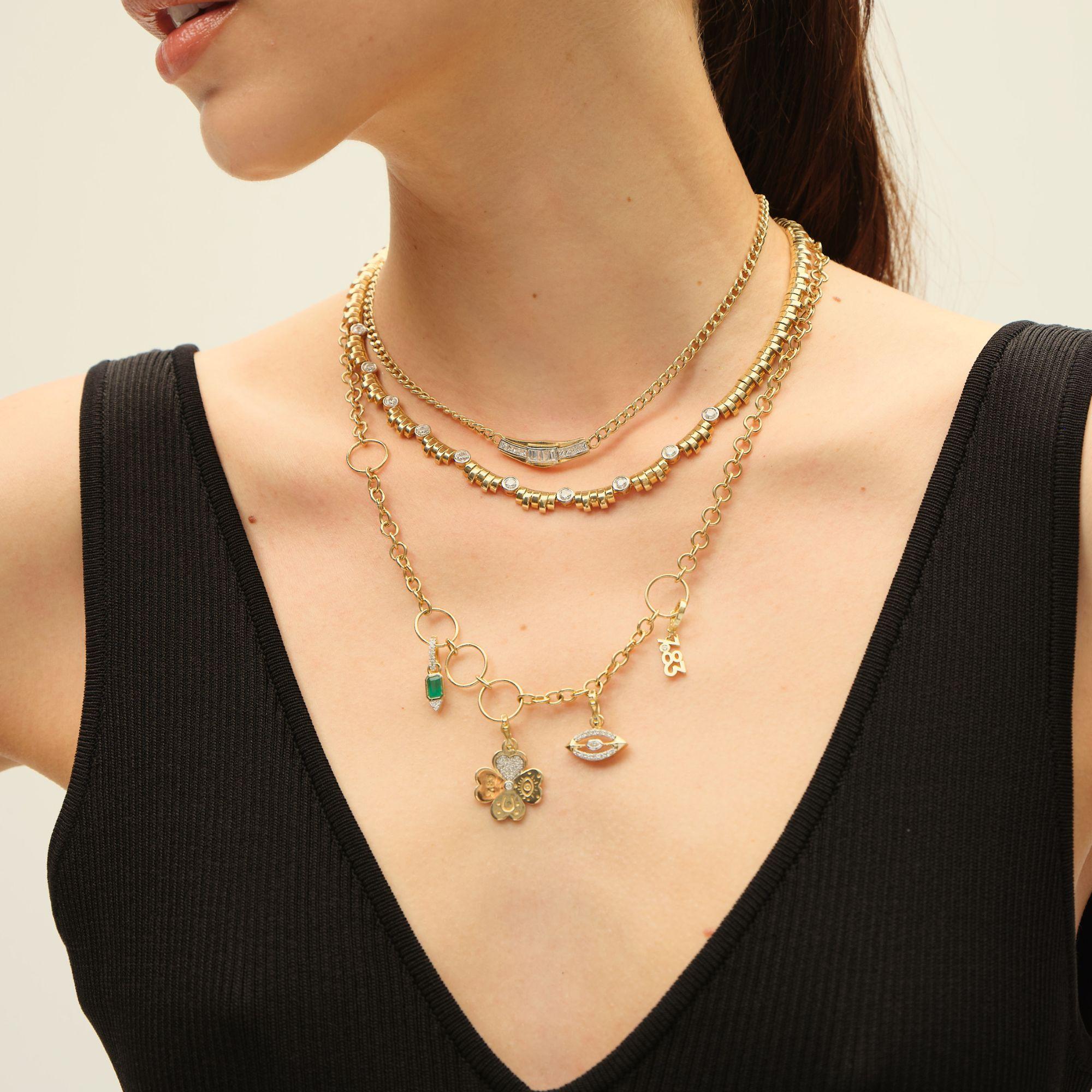 This refined necklace showcases a flexible tubogas design in 14 K yellow gold, accented with 10 solitaire round diamonds for a touch of brilliance. Its timeless yet modern style makes it perfect for layering or wearing solo as a statement