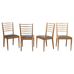 Series of 4 vintage chairs in wood and leatherette