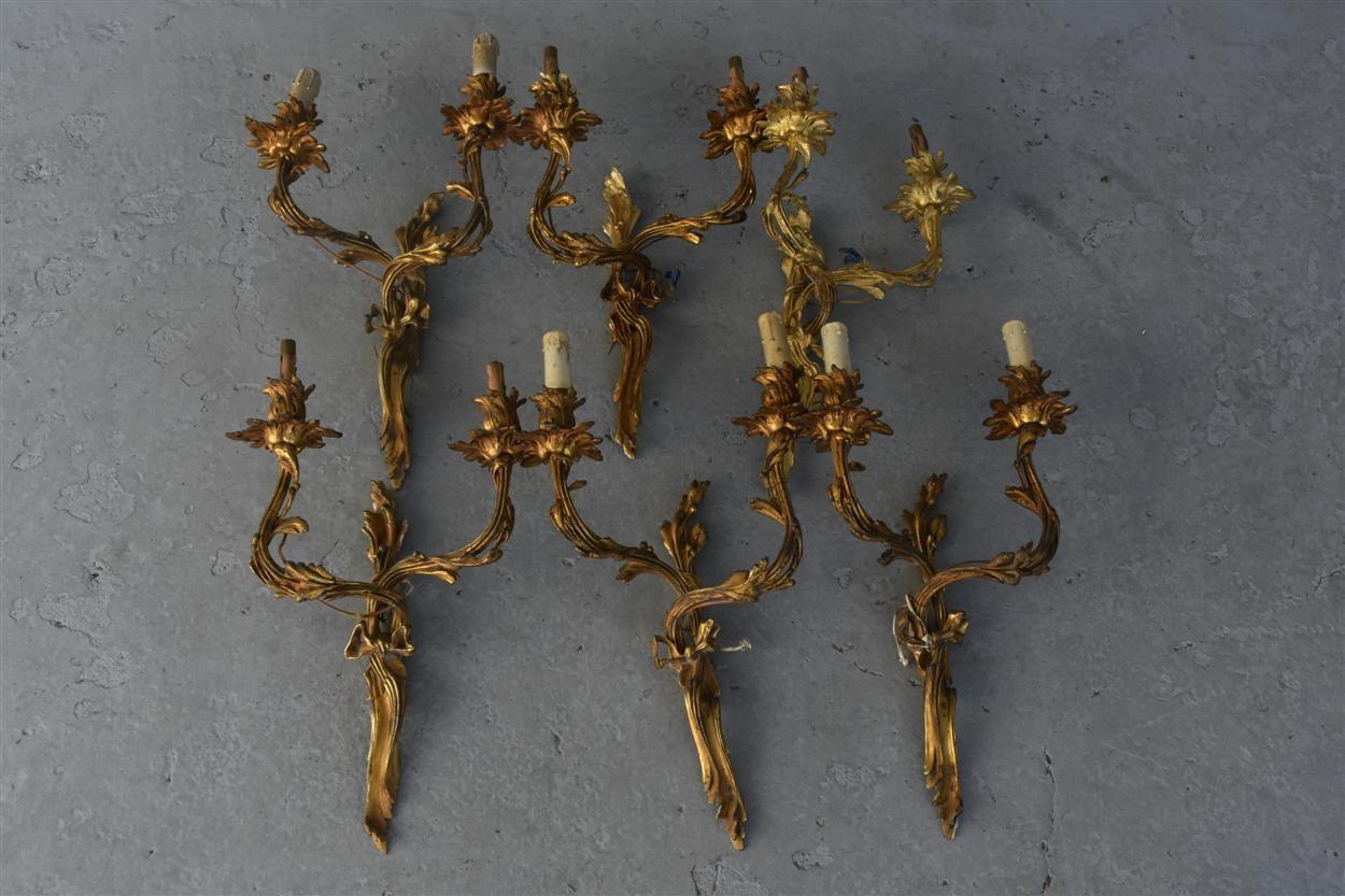 Serie of 6 of beautiful Louis XV style gilt bronze two-light wall-lights, each of asymmetrical Rococo outline, the highly ornate scrolling ribon. The whole fixture almost bustling with life, with foliage adding to the vibrancy and energy of the