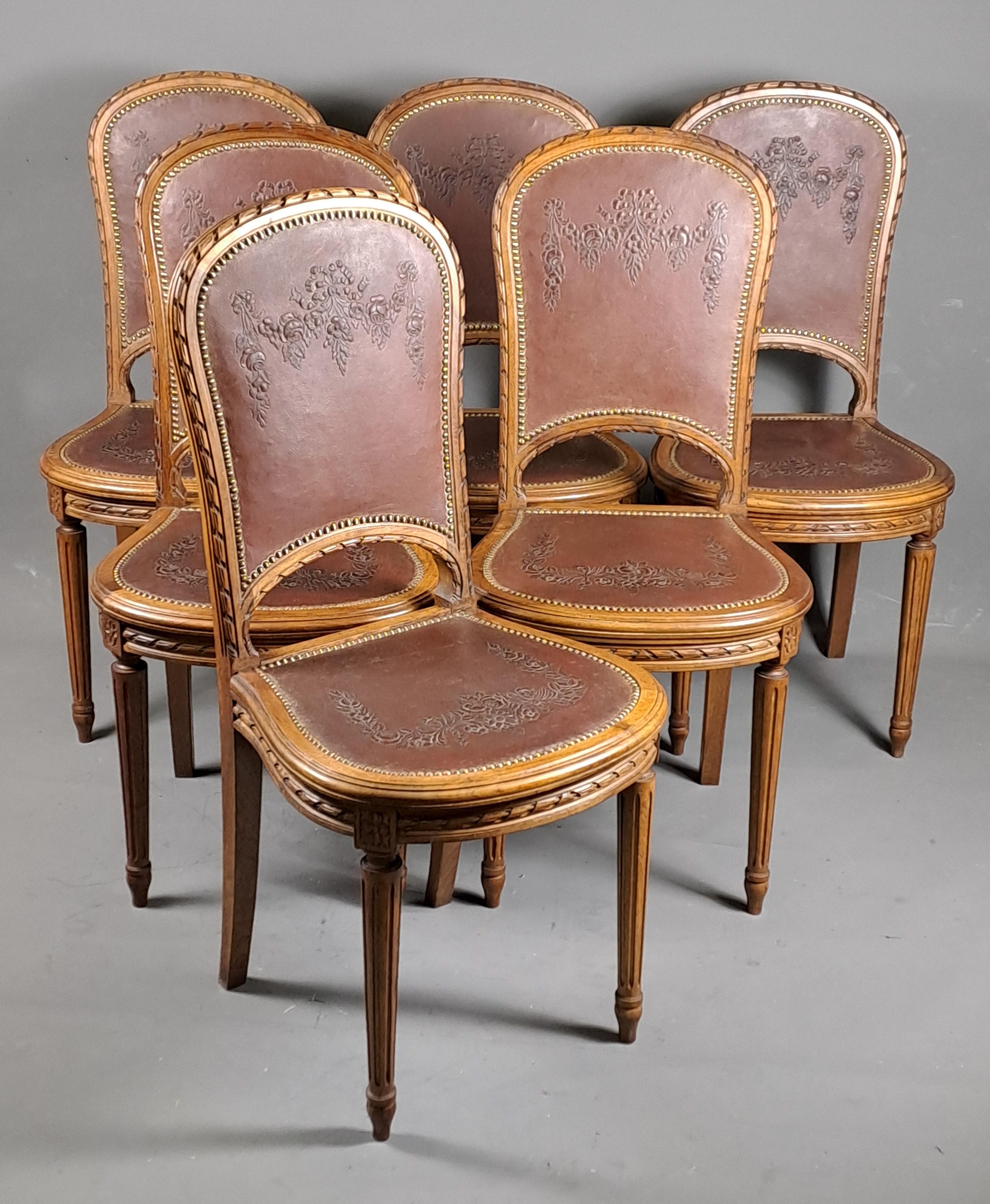 Beautiful series of 6 Louis XVI style chairs in very finely carved solid walnut and embossed Cordoba leather trim decorated with flower garlands.

French work around 1900

Very good condition, stable and healthy seats, leather in excellent condition