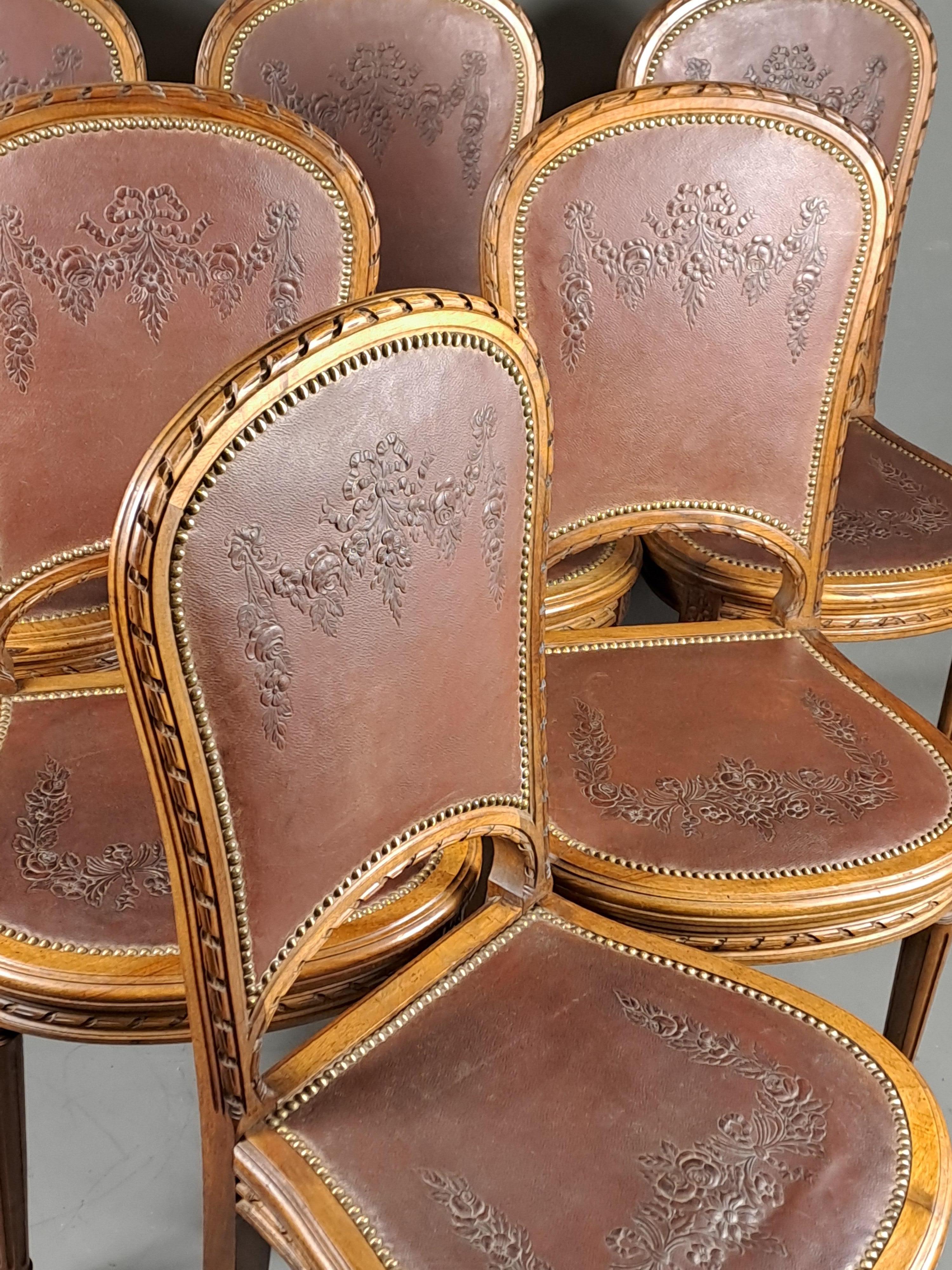 Carved Series Of 6 Louis XVI Style Chairs In Solid Walnut And Embossed Cordoba Leather  For Sale