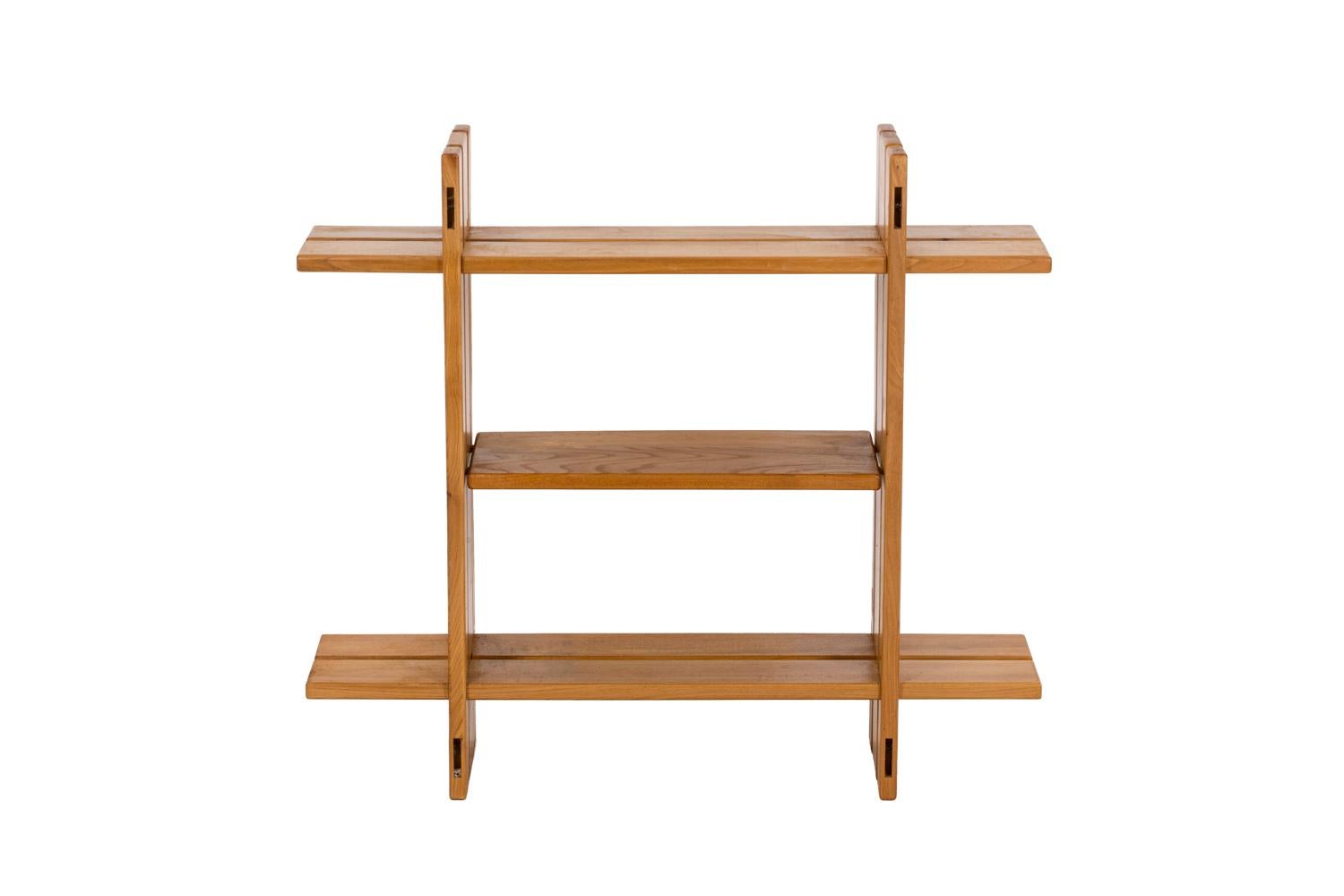 Maison Regain, attributed to.

Series of five square-shaped shelves formed by four assembled boards. A fifth removable board disposed in the center lets modify the height of the shelf. 

French work realized in the 1960s.
  