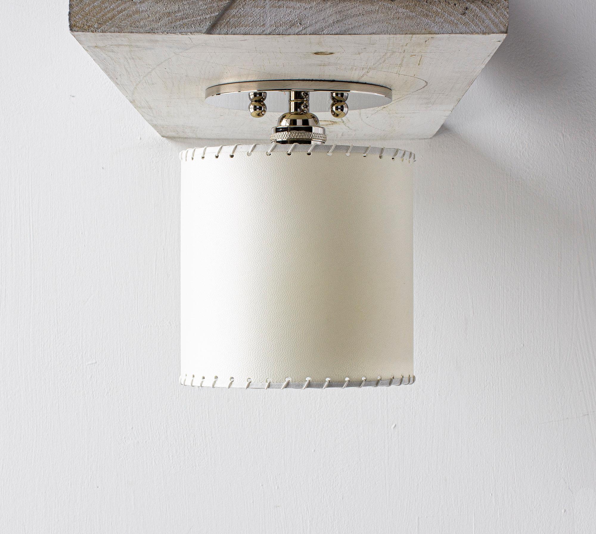Solid machined brass, hand-stitched goatskin parchment shade with diffuser. 

Shades are made from genuine goatskin parchment, hand-selected for each lamp for its natural texture, pattern and color. Reminiscent of the lunar surface, its superior