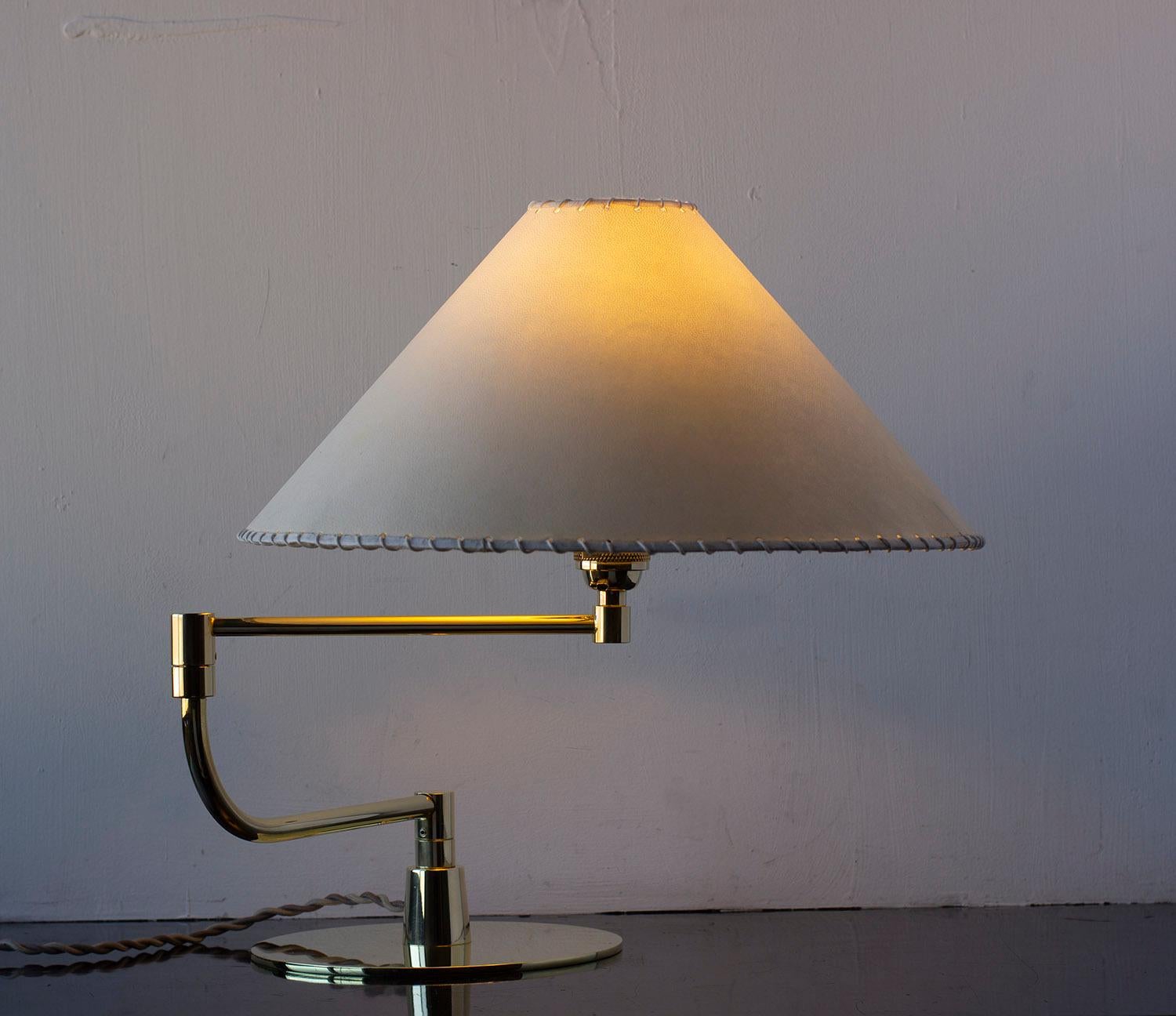Solid machined brass and goatskin parchment shade with hand-dyed braided cotton cord. Adjustable pivot arm. 

Shades are made from genuine goatskin parchment, hand-selected for each lamp for its natural texture, pattern and color. Reminiscent of the