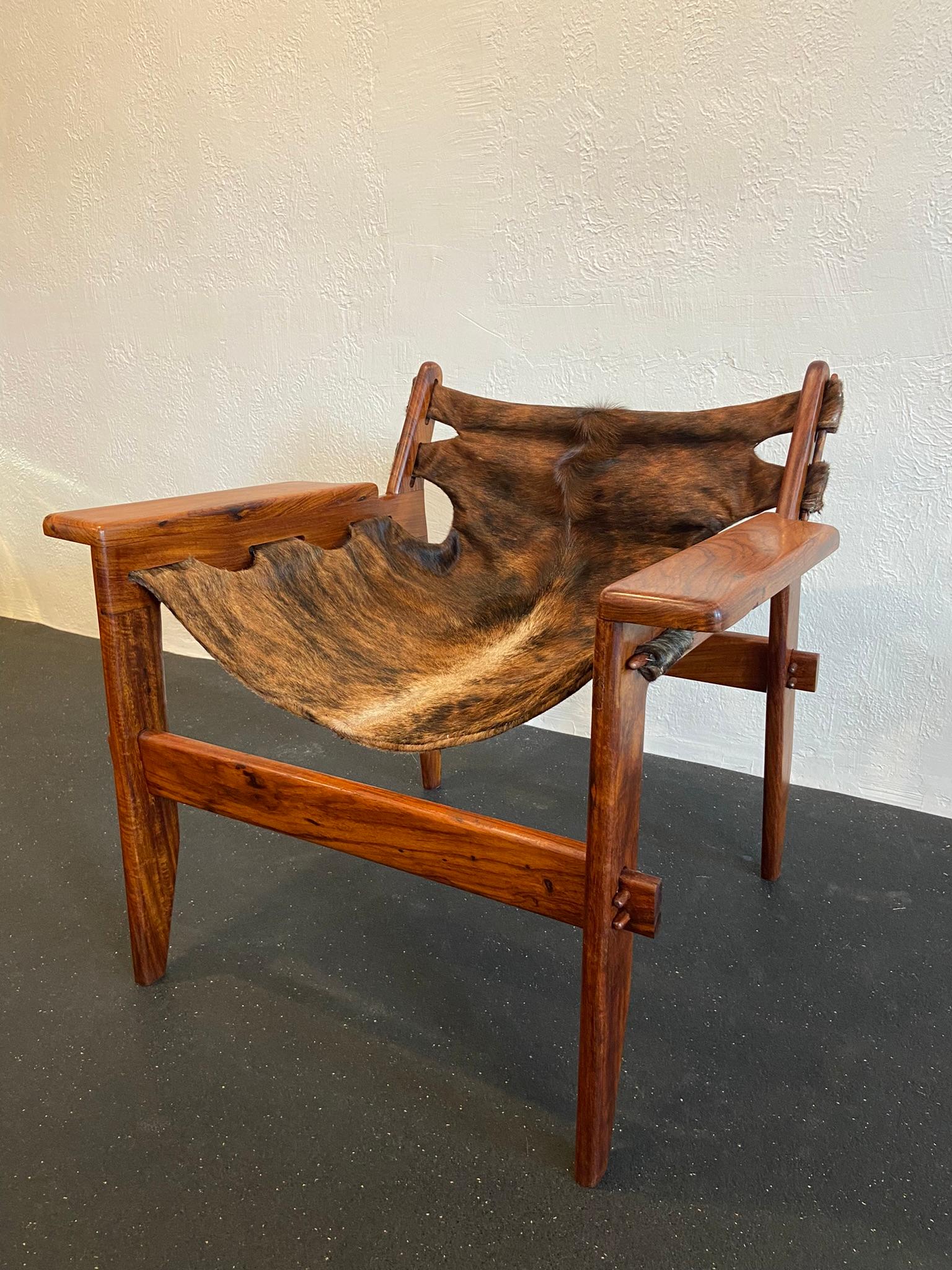 Sergio Rodrigues style rosewood sling chair. The frame has been refinished and the sling updated to an exotic hair on hide. Design is reminiscent of the Kilin chair by Sergio Rodrigues. 

Would work well in a variety of interiors such as modern,