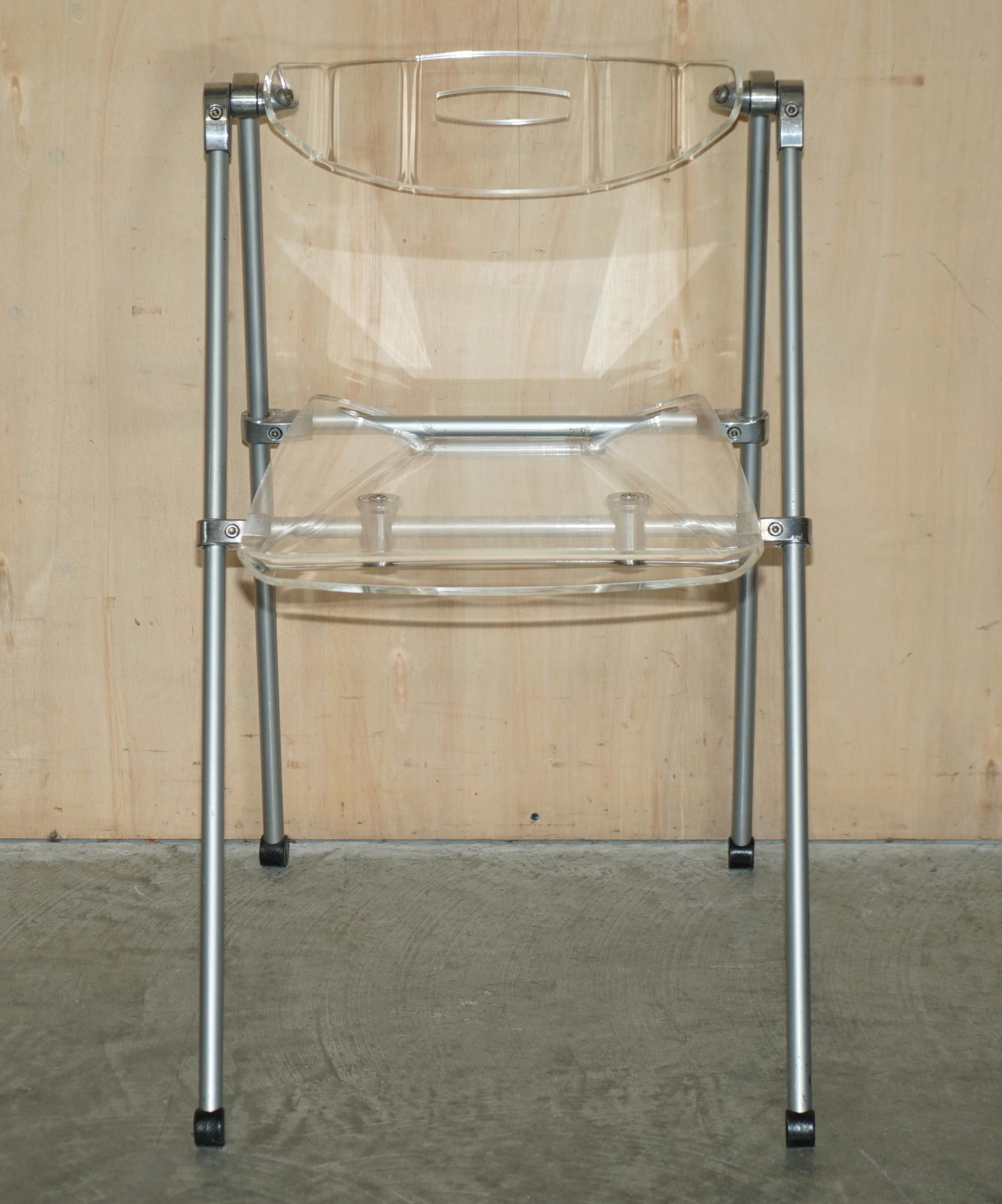 We are delighted to offer for sale this very cool over engineered lucite and steel folding chair with swinging back rest

A very well made chair, the frame is super industrial and it has a thick comfortable Lucite set and back rest. The back rest