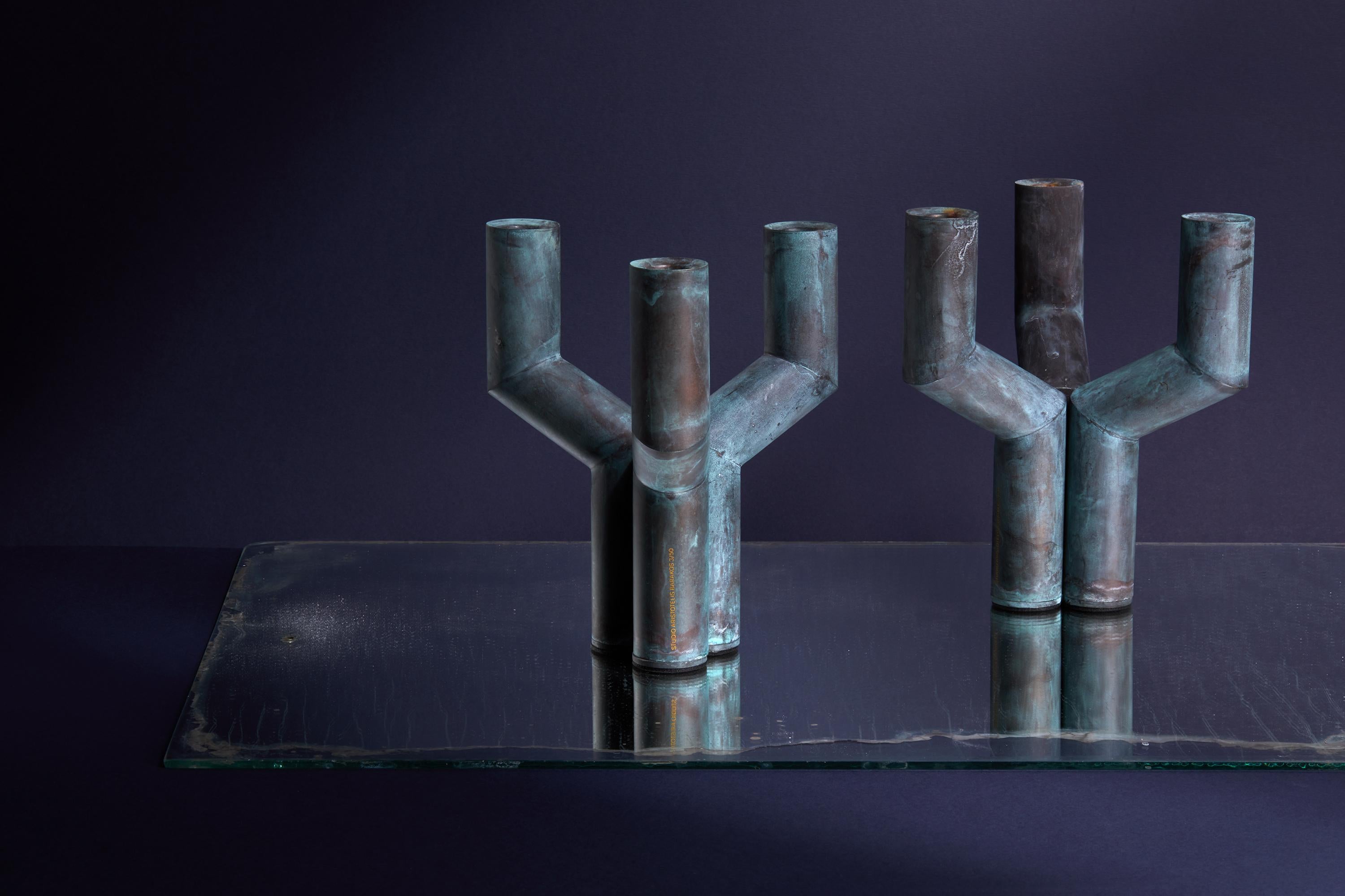 Sermon Verdigris is a limited-edition brass candleholder by Studio Aristotelis Barakos.

It is a meticulously finished object that exudes an antique allure, its surface transitioning from deep black to timeless verdigris green, echoing ancient