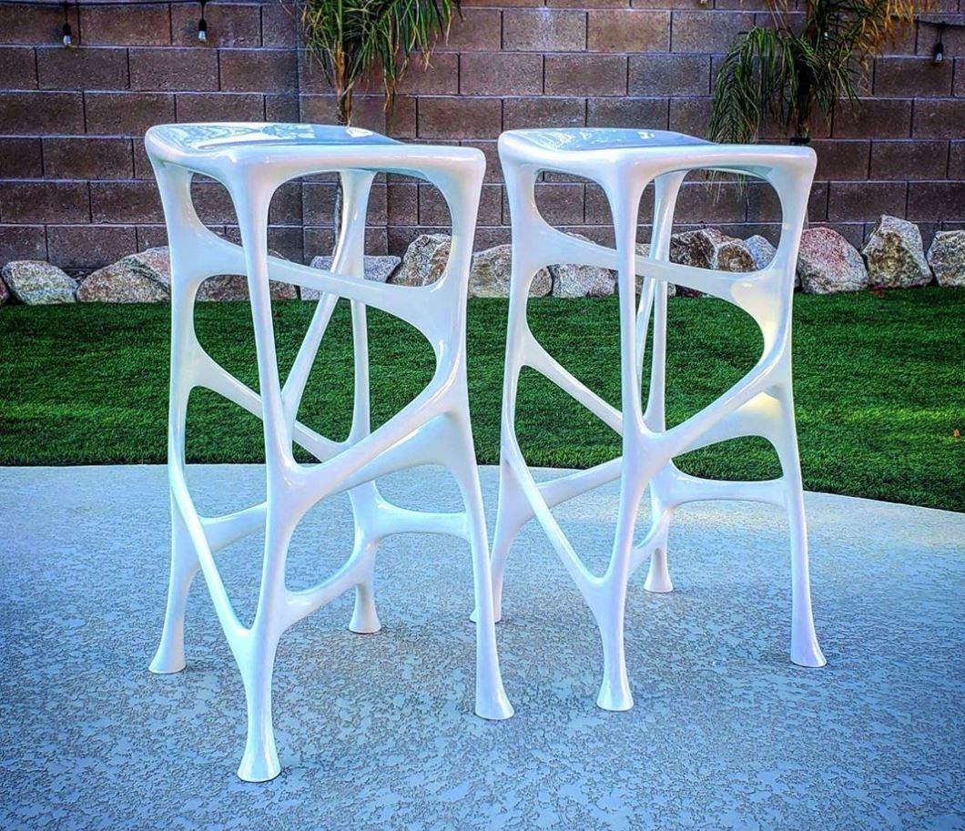 Limited edition set of two in gloss white, featured in marvel studio's Black Panther film in the technology lab scenes. Serous is a modern piece of furniture art defined by its infinite geometrical lines, modern aesthetics, and fluid design. The