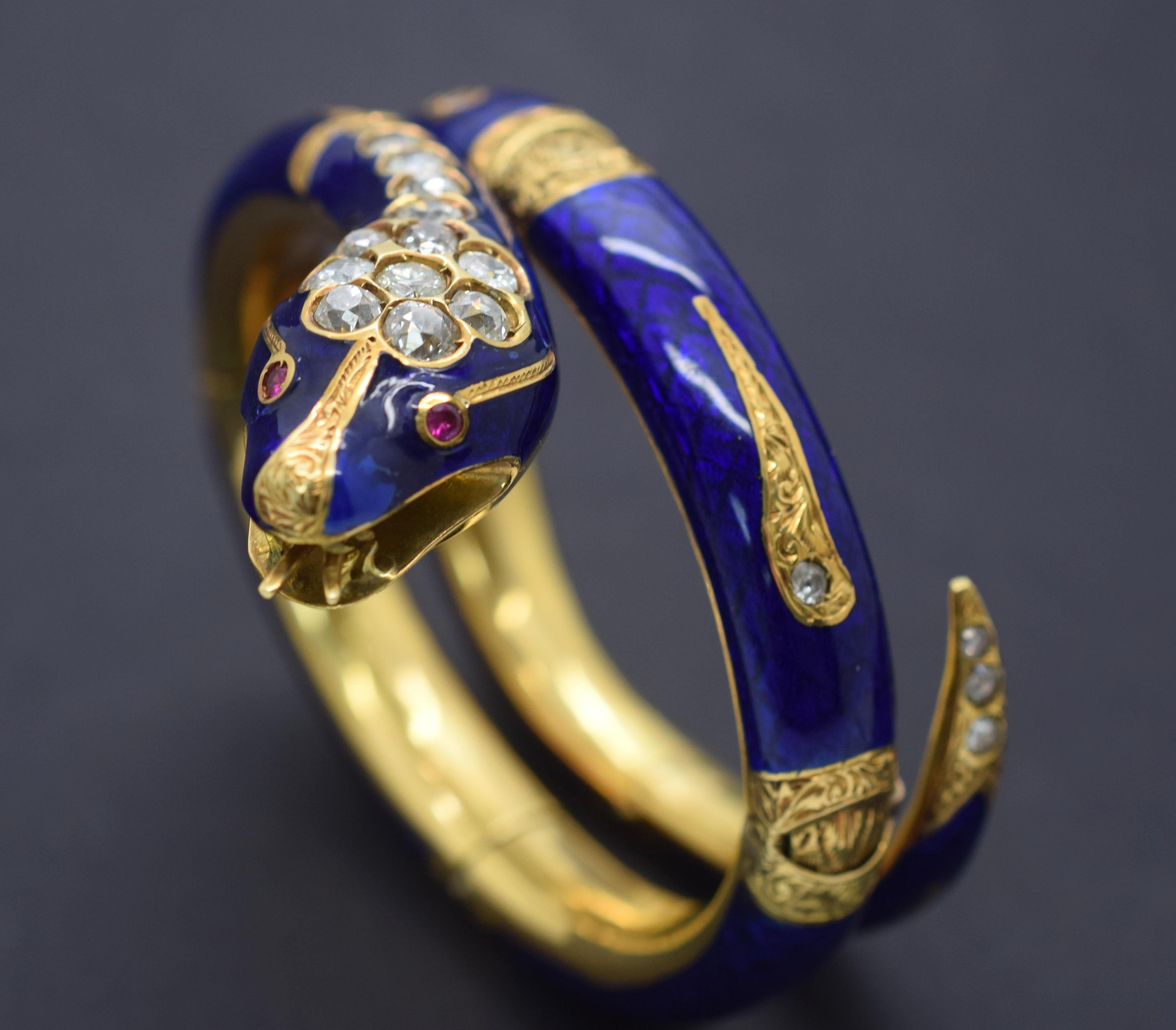 Gorgeous snake bracelet crafted in 18k yellow gold with vivid blue hot enamel on the surface. This Art Nouveau bracelet was hand crafted by master's of their time. Details are shown through out, engraving and filigree are shown on every piece of