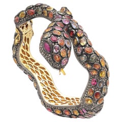 Bracelet « Serpent » en argent et argent doré, avec des saphirs multicolores et une taille « rose »