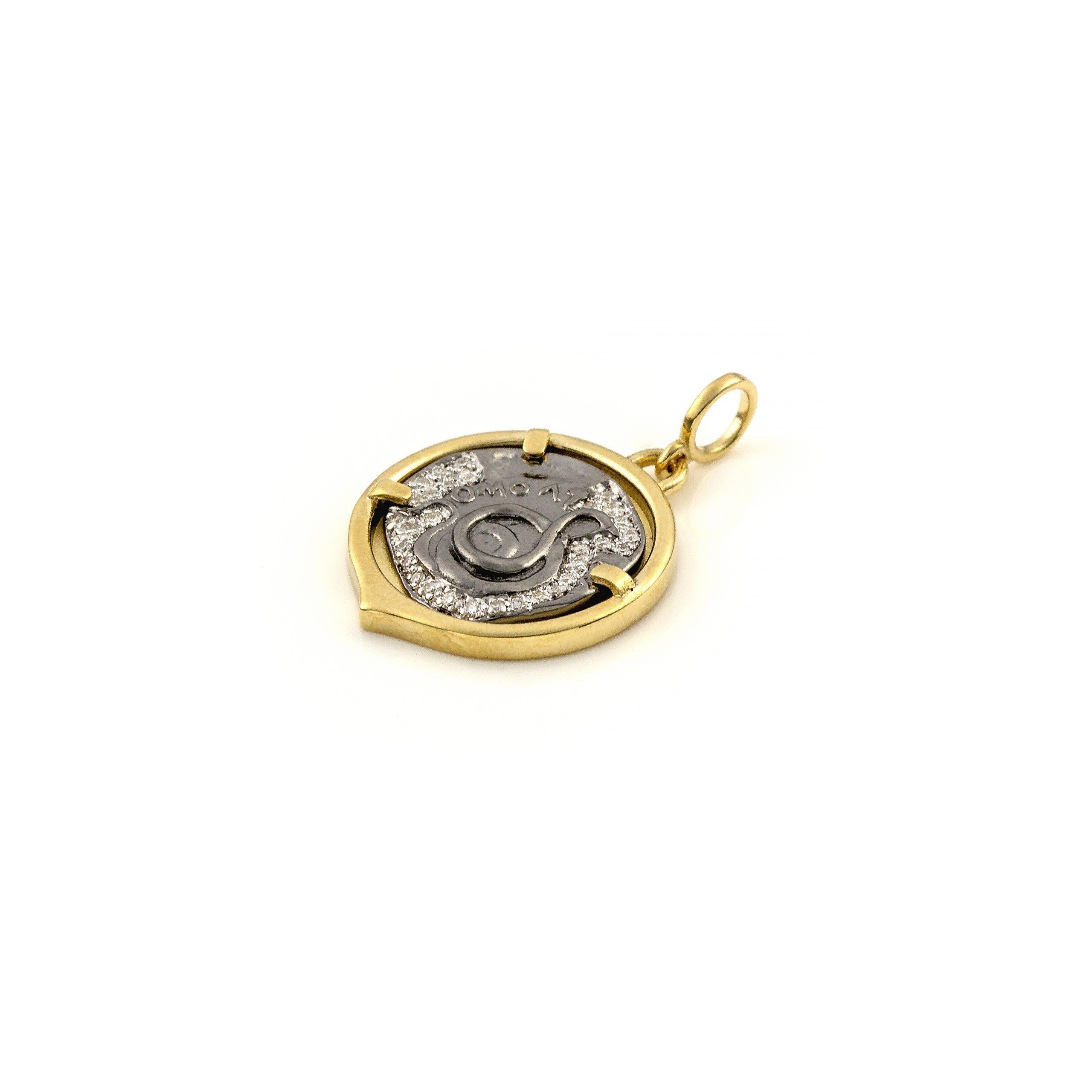 Recycled 14K Yellow Gold

Sterling silver Rhodium plated

Diamonds Approx. 0.15 ct

Jewel size: 2.8×1.9 cm/ 1.1×0.79 inches
The pendant is sold WITHOUT a chain.

Serpent Coin Pendant in Golden Case in Diamonds .

Asclepius, the father of medicine,
