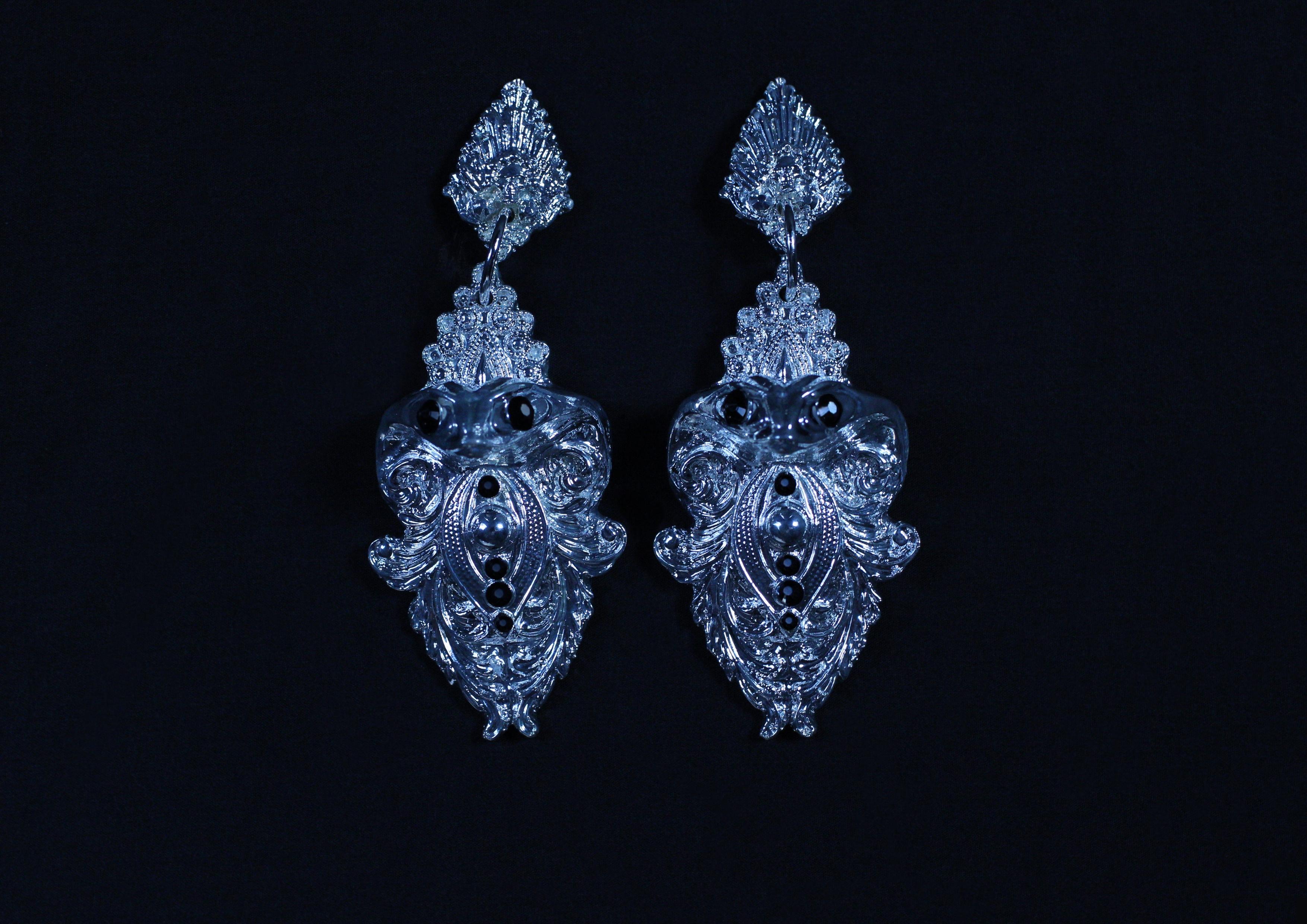 Serpent Earrings by Angelis Blade

With intricate detail and bold design, the Serpent earrings capture a mystique that’s both enchanting and powerful. Each earring features an elegantly sculpted cobra, adorned with black-hued diamanté eyes and